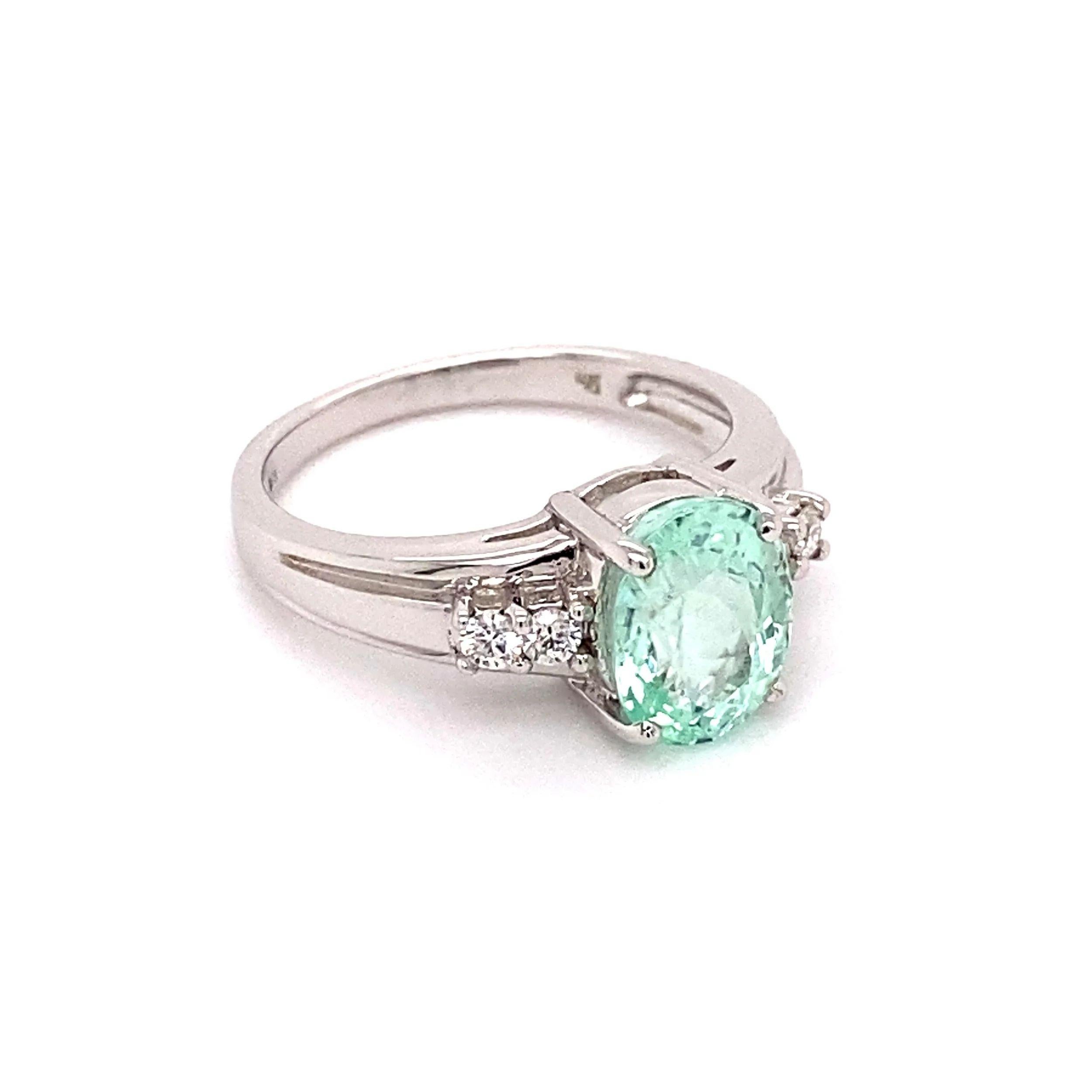 Simply Beautiful! Finely detailed GIA Oval Bluish Green Paraiba Tourmaline and Diamond Gold Ring. Either side set with Diamonds, approx. 0.18 total carat weight. Dimensions 1.00” l x 0.81” w x 0.35” h. Hand crafted in 14K White Gold. The Paraiba