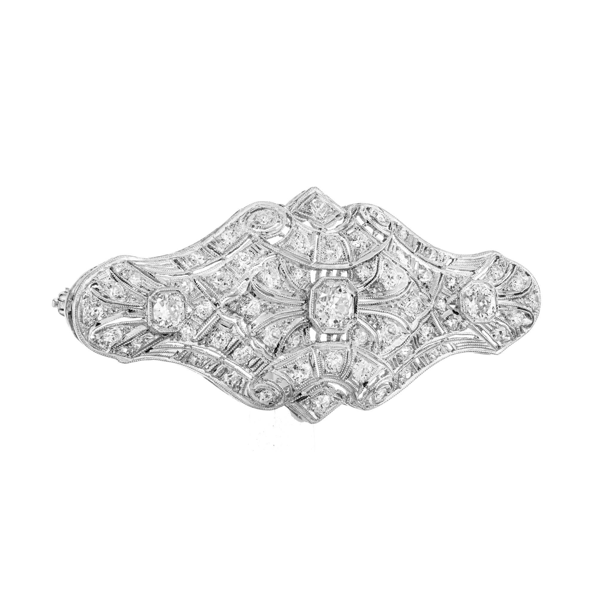 1920's Exquisite Old European Diamond Art Deco Domed Platinum Brooch. This stunning piece of jewelry boasts three Old European cut diamonds that combined, total an approximate carat weight of .98cts. which are accented by 56 round diamonds. Crafted