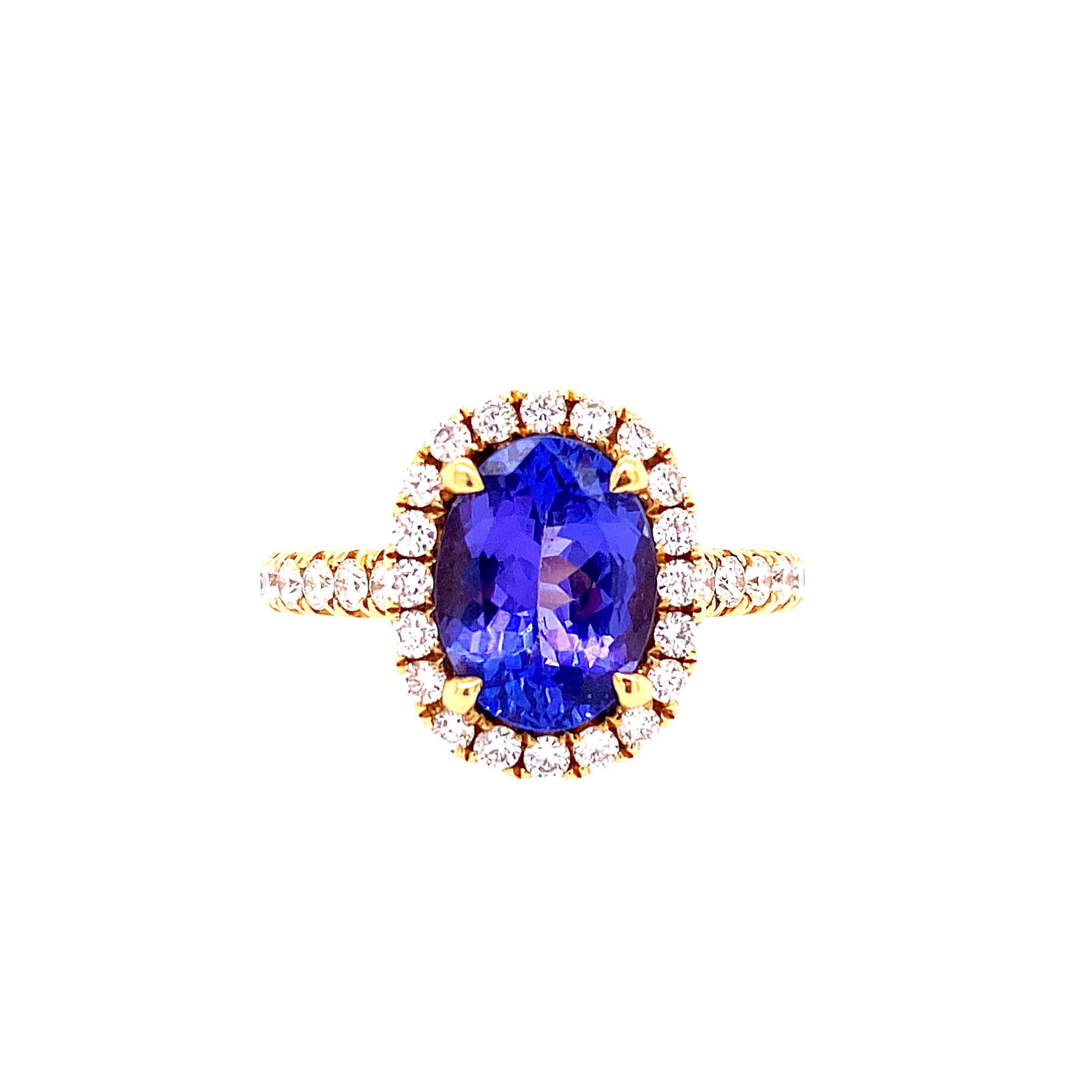 This stunning Cocktail Ring showcases a beautiful 2.48 Carat Oval Tanzanite with a Diamond halo. This Ring has a Diamond Shank and is set in 18K Yellow Gold. Total Diamond Weight = 0.60 carats. Ring size is 6 1/2.