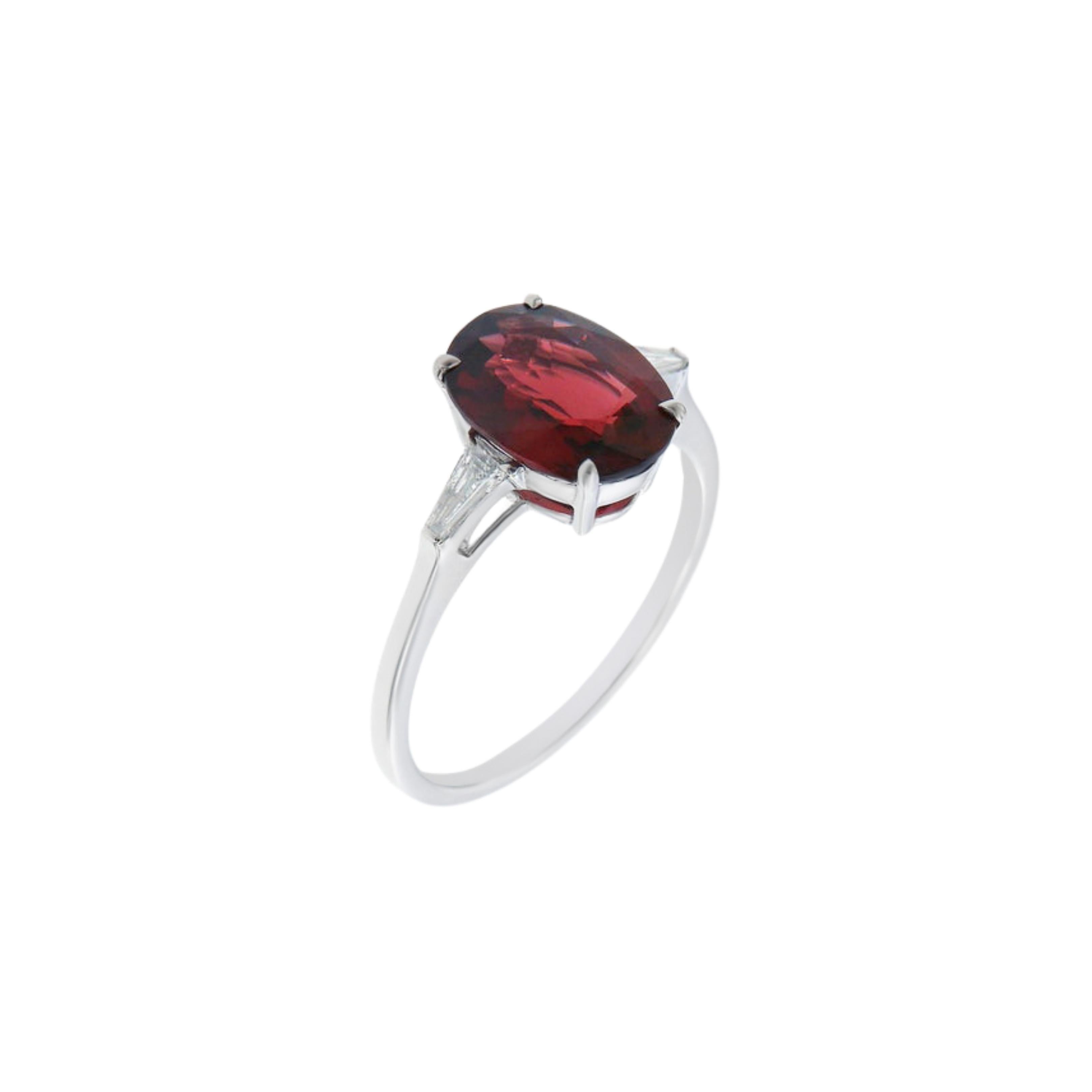 This beautiful Oval Red Spinel is a natural non heated 2.48ct stone. Beautifully set with accent tapered baguette diamonds in G VVS quality and set in high polish 18k white gold. 

Ring Size
EU 52 
USA 6

This ring can be resized for the customer