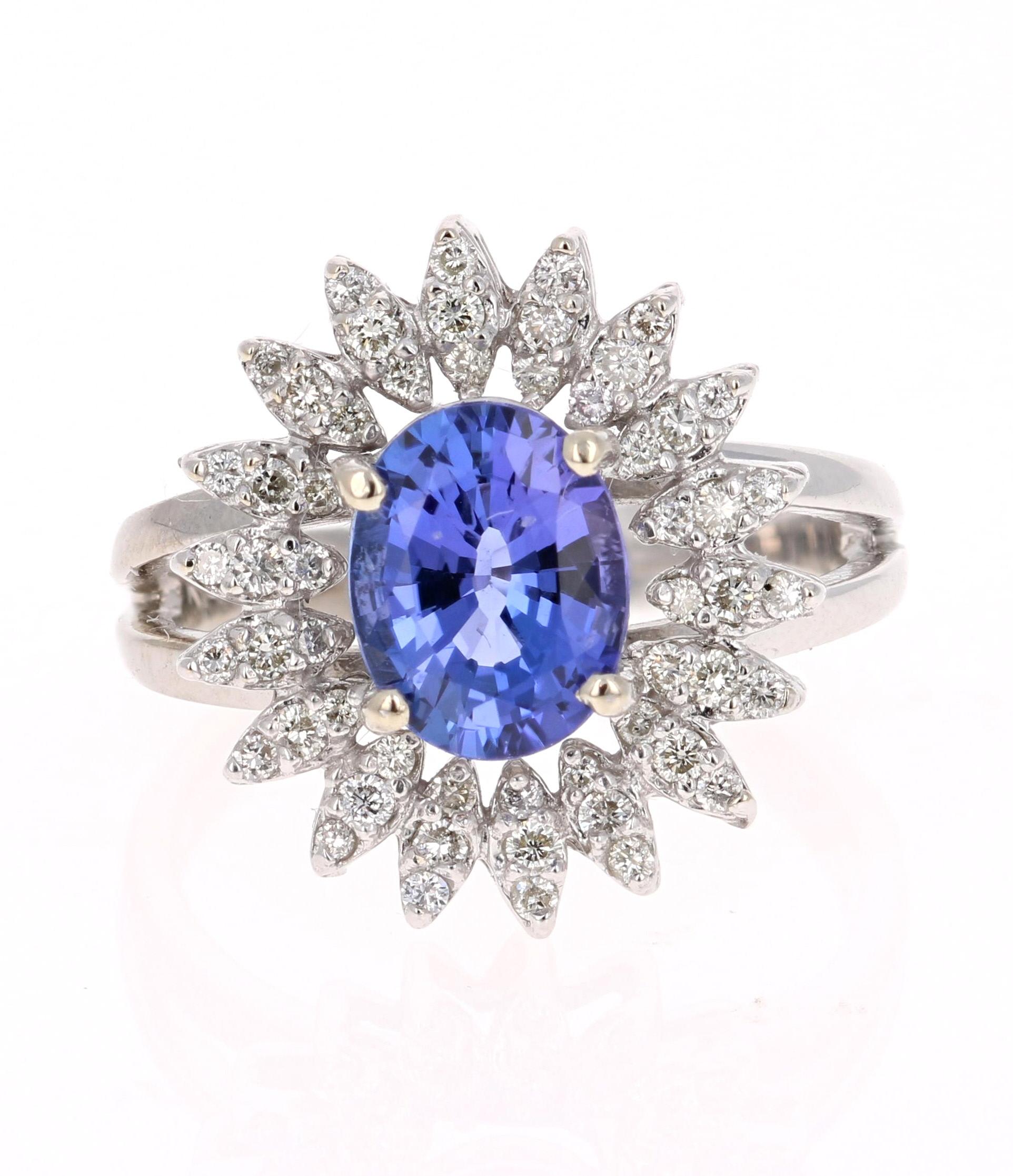 This gorgeous Tanzanite Diamond Ring has a 2.00 Carat Oval Cut Tanzanite as its center stone and has 54 Round Cut Diamonds that weigh 0.48 Carats. The setting has a beautiful design that can be viewed as a unique flower. The Total Carat weight of