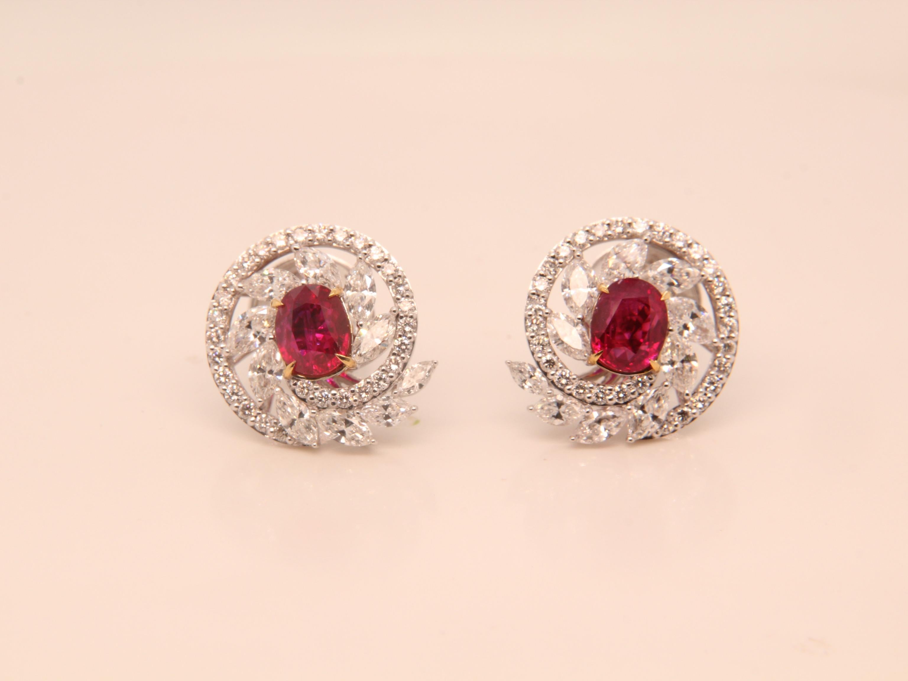 A brand new ruby and diamond earring by Rewa. The Burmese 'Pigeon Blood' ruby weigh 1.34 and 1.14 carat each and they are both certified by Gem Research Swisslab (GRS). The rubies are surrounded by 2.65 carat diamonds studded on 18k white gold 8.78