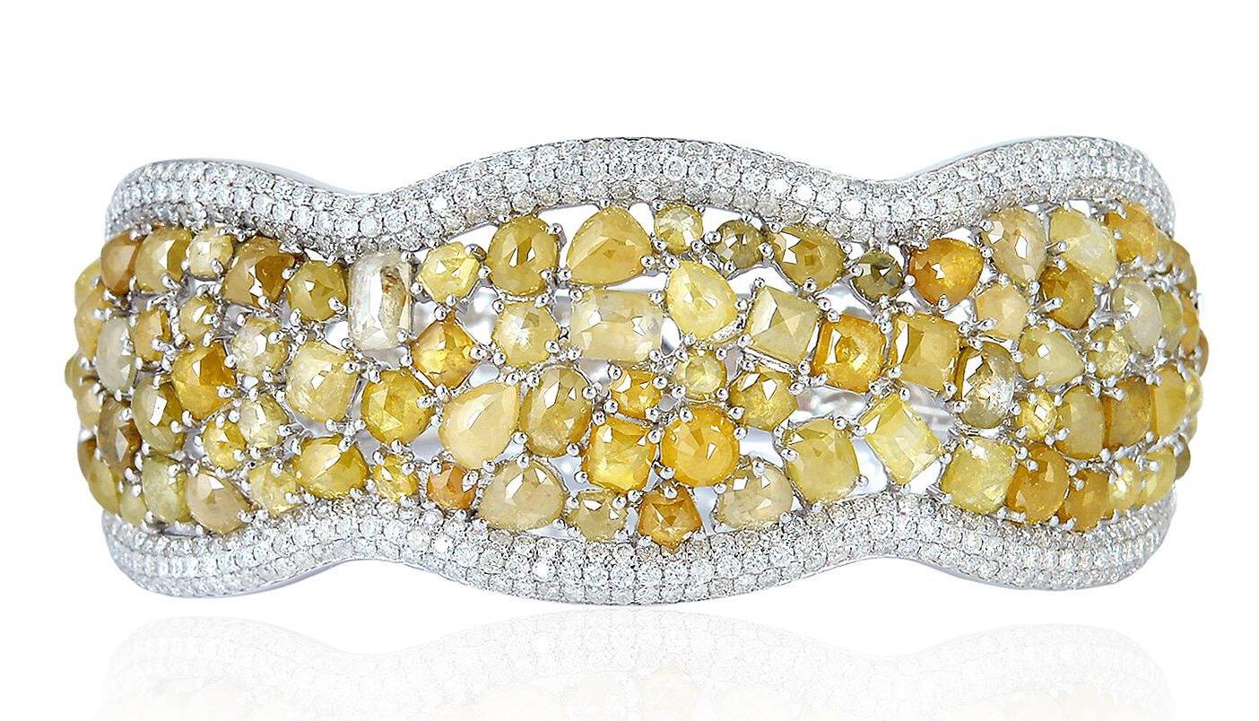 Ein atemberaubender Armreif, handgefertigt aus 18 Karat Gold. Er ist mit 24,83 Karat gelben und weißen Fancy-Diamanten besetzt.  Kombinieren Sie es mit Ihrem Lieblingsabendkleid für einen Look wie auf dem roten Teppich.  Spange Verschluss

FOLLOW 