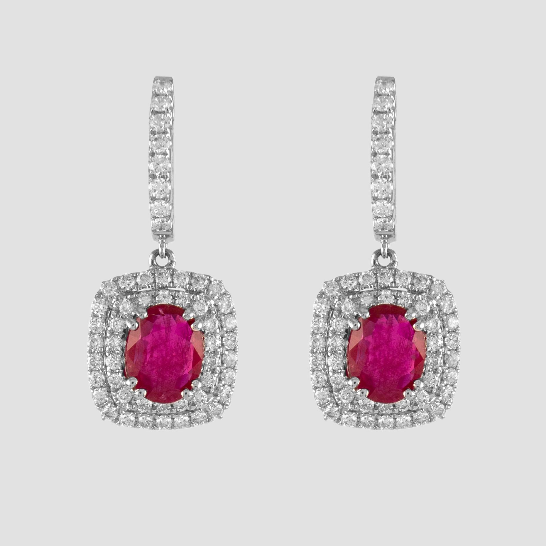Sensational ruby and double diamond drop earrings.
2 oval rubies, 2.48 carats total. Complimented by 104 round brilliant diamonds, 1.15 carats. Approximately G/H color and SI clarity. 18k white gold. 
3.63ct total gemstone weight. 
Accommodated with
