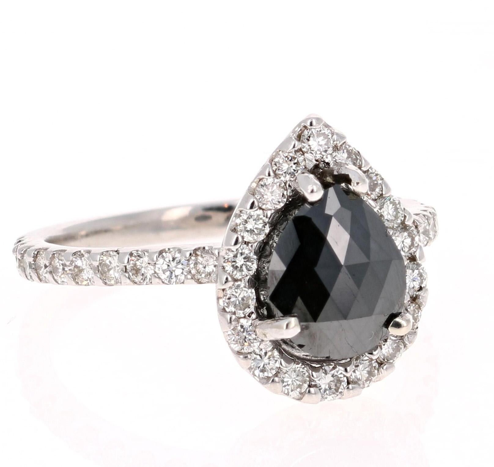 A stunner that can transcend into a unique engagement ring!! This ring is made in 14K White Gold and weighs approximately 3.5 grams. 

The Black Diamond is a Pear Cut and weighs 1.77 carats. The Black Diamond is a natural diamond that has been