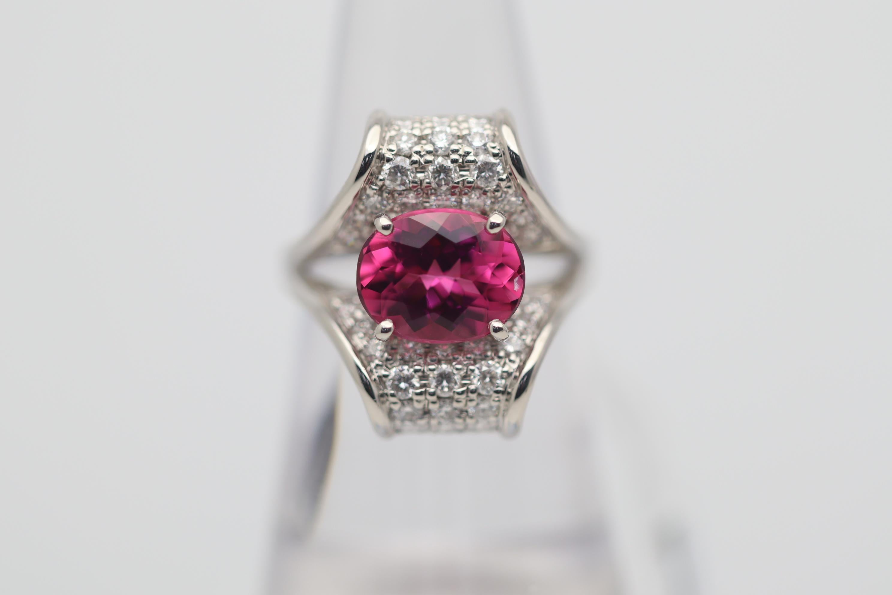 A sweet and juicy rubellite tourmaline takes center stage! It has a bright vivid pink-red color and weighs 2.49 carats. It is complemented by 0.96 carats of round brilliant-cut diamonds adding extra sparkle and brilliance to the ring.