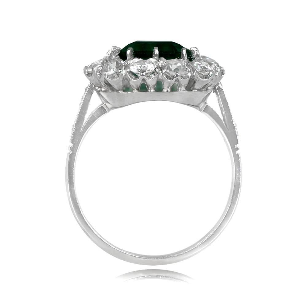 Prepare to be captivated by the stunning beauty of this ring. Its focal point is a mesmerizing 2.49-carat emerald-cut natural emerald, delicately set in prongs, radiating vibrant green hues and captivating allure. Surrounding the gemstone is a