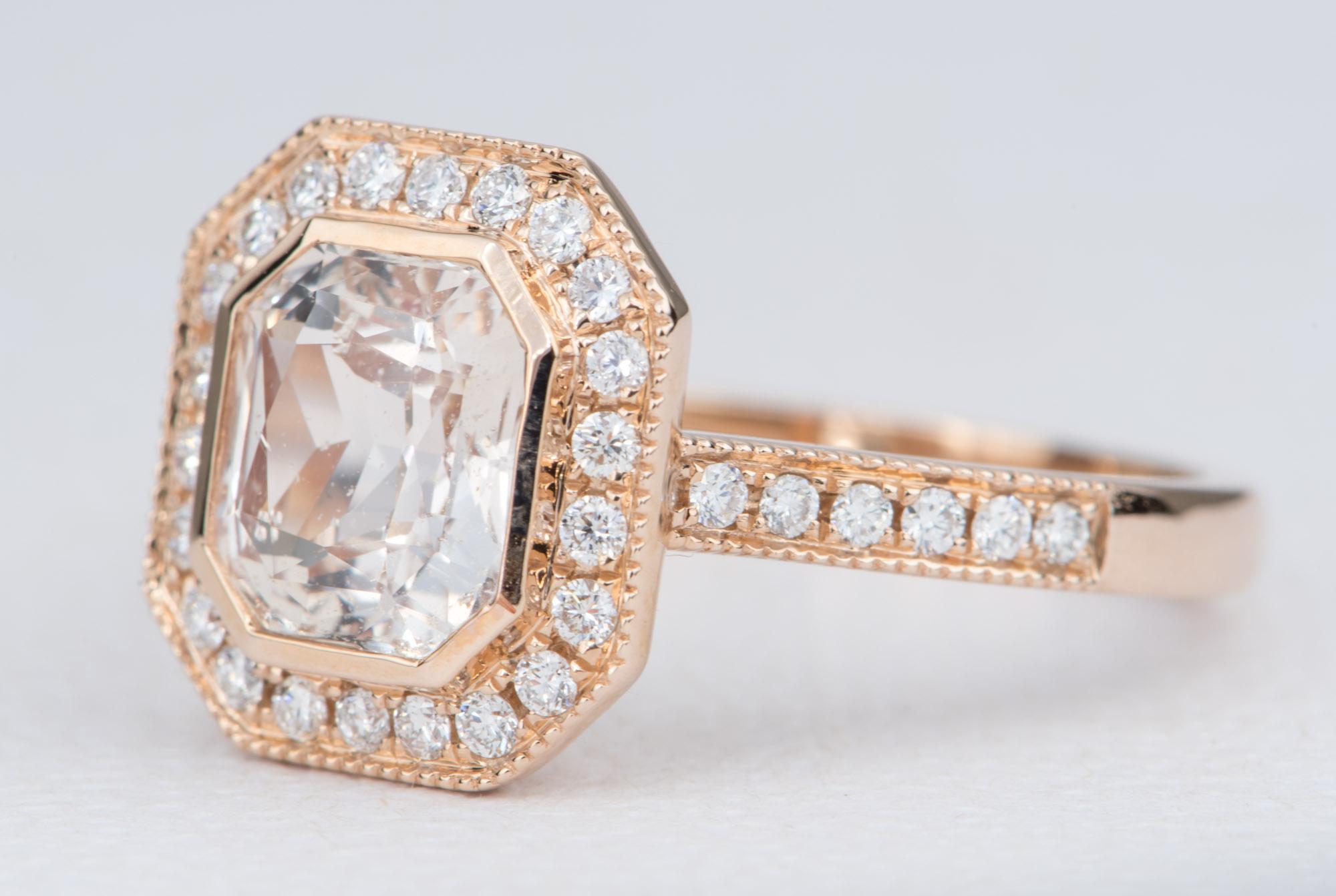 ♥  This is a stunning ring featuring a light peachy-pink sapphire in the center, flanked by a row of bright white diamond halo with milgrain edges. The shank of the ring is also set with bright white diamonds with a delicate milgrain edge.

♥  Ring