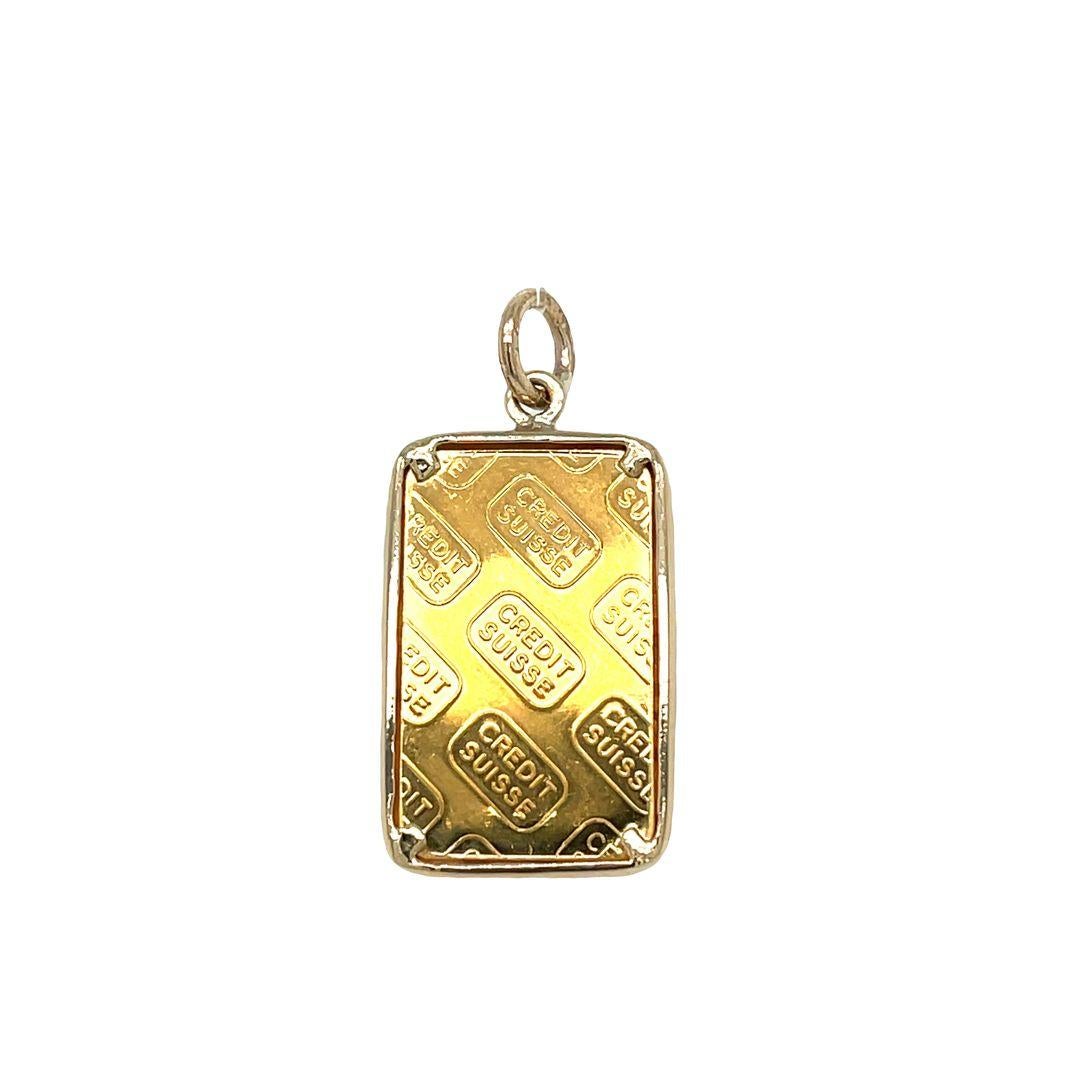 This exquisite pendant features a 5 gram Gold Credit Suisse bar, wrapped in the radiance and warmth of a solid yellow gold bezel. Measuring a substantial 26.5 mm in length and 16.5 mm in width. It weighs 7.4 grams (with bezel and bale). Please note
