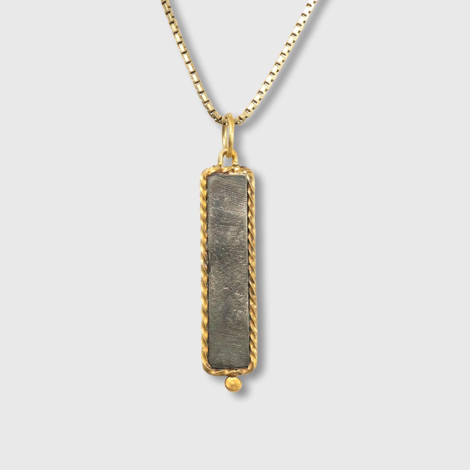 Framed, 24kt Yellow Gold, Long Blue & Silver, Enameled Pendant with 0.02 Diamonds

Size - Small, 1.25 inches long
24k Gold - 1.82 grams
SS 925 - 1.40 grams

Enamel jewelry has been around since the 13th century B.C.E. Since then, it has evolved and