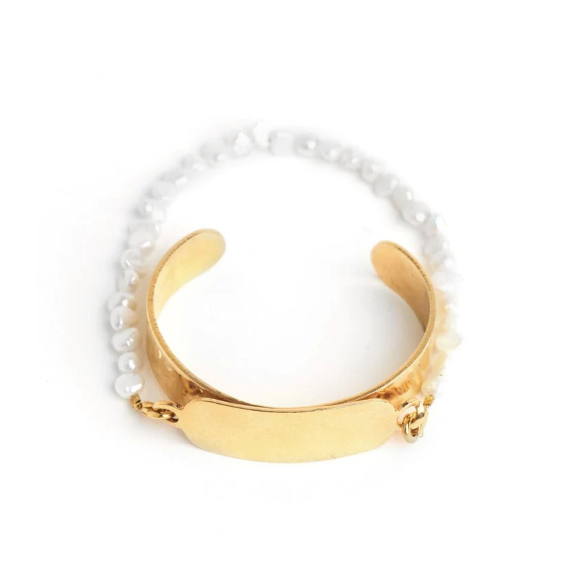 A new twist on a classic. Bet you never seen it done like this! Super chic removable freshwater pearl strand attached by lobster clasps to our classic ID cuff. Strand can be worn separately as well.

Additional Information:
Material: 24K Gold,