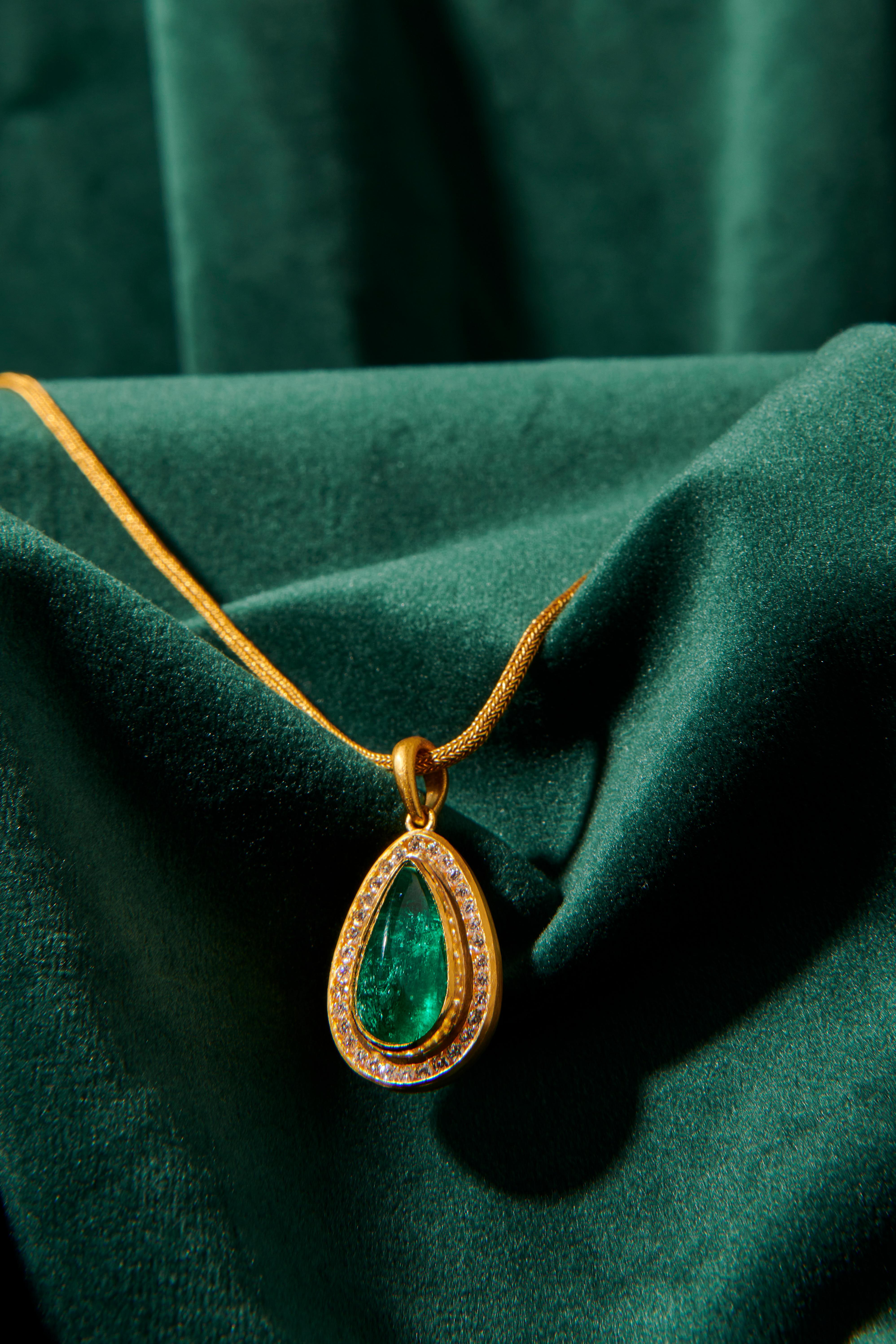 Emerald (6.90 Carat) and Diamonds (0.54 Carat) 
Please note that it is just the pendant, the chain is not included. 

Crafted with timeless elegance, this 24 karat gold jewelry piece draws inspiration from the ancient civilizations of Anatolia,