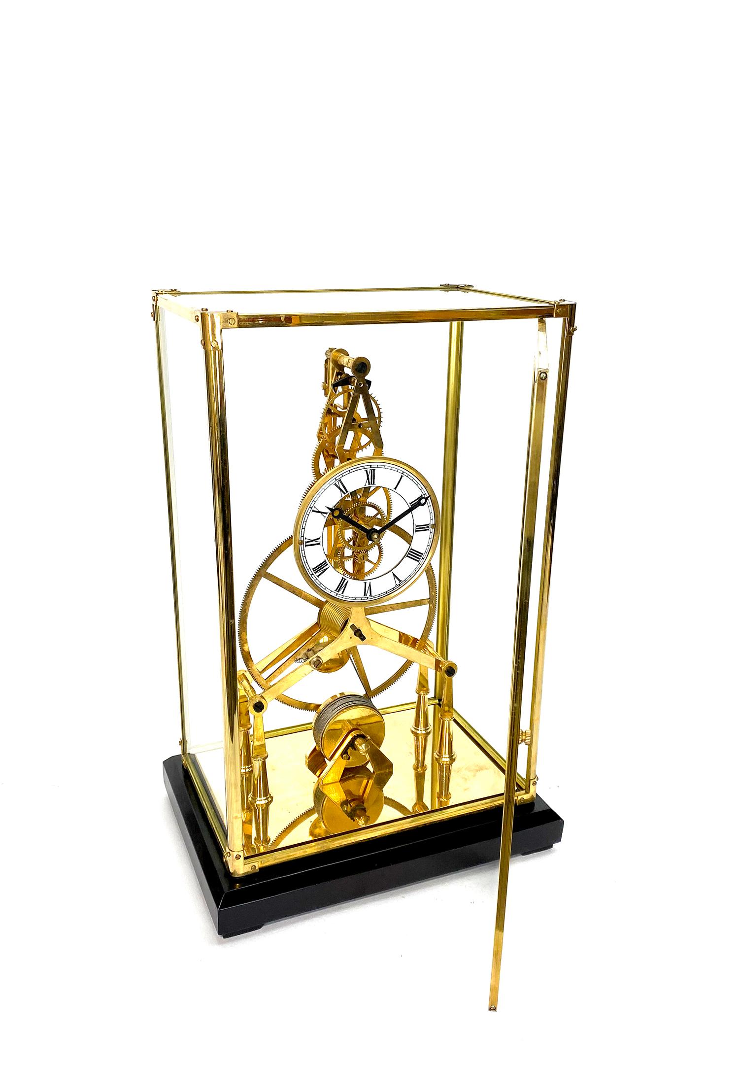 24K Gold Plated 8 Day Great Wheel Fusee Driven Porcelain Dial Skeleton Clock

Here is a very nice looking 24K plated large skeleton clock, housed inside a brass frame glass case. It has a front opening door, so you can easily set and wind the clock.