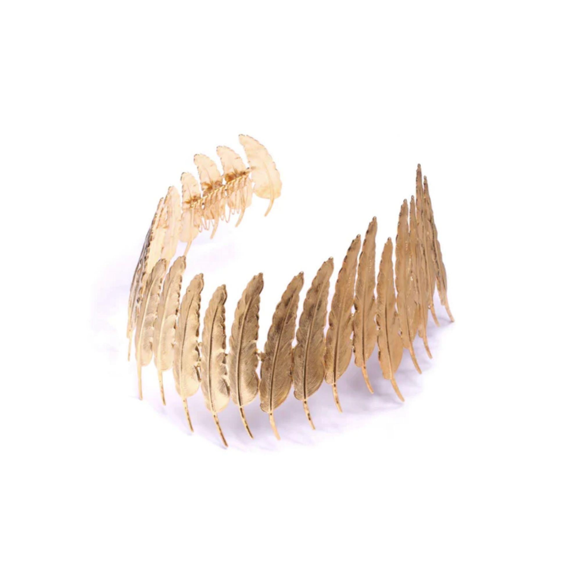 One of a kind crown worn with hidden combs securing the headpiece on. This intricate piece is all hand made with each feather hand soldered to the next and then plated in 24k gold. Plated on Brass. Made in America.

Additional Information:
Material: