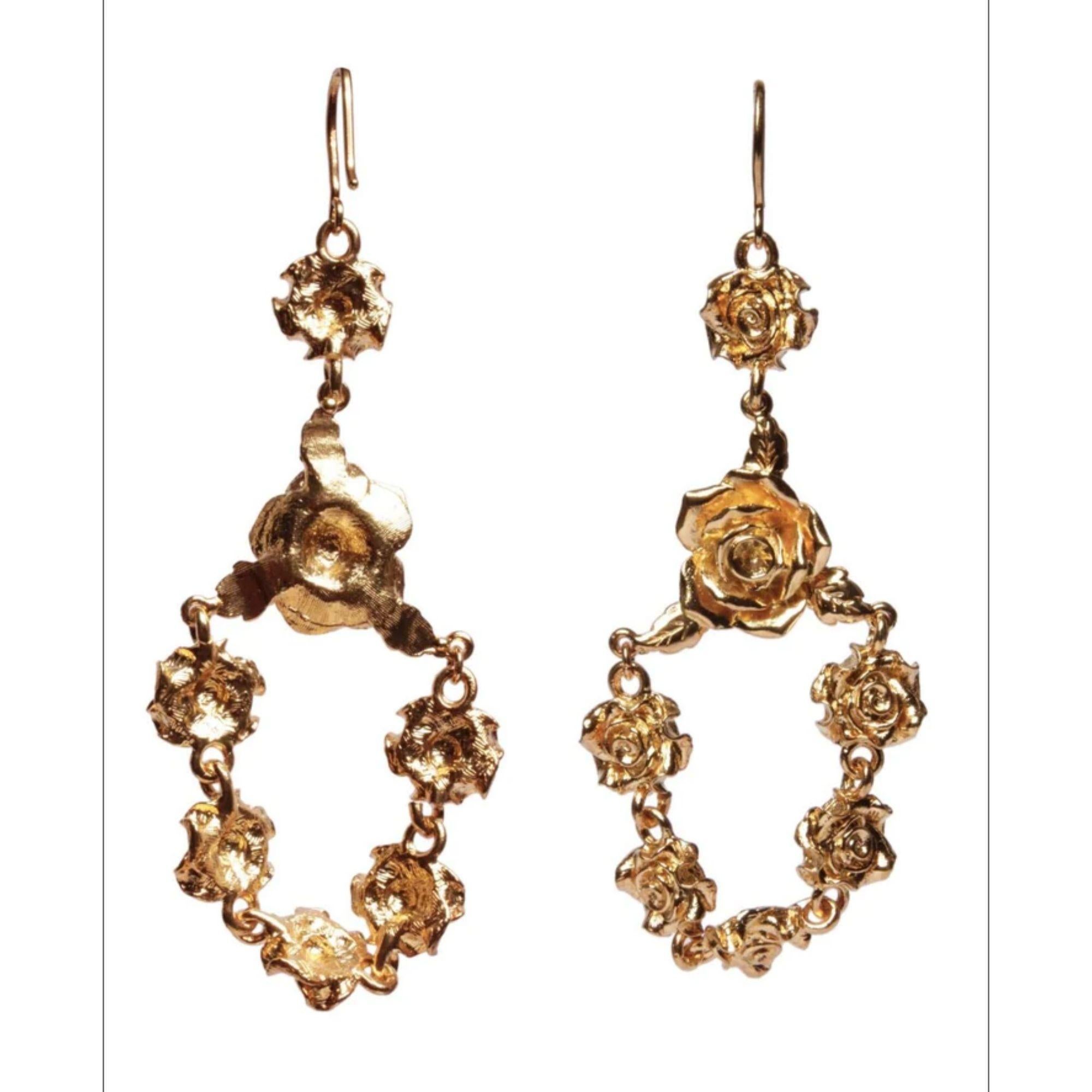 Frame your face in a delicate bouquet of rosettes! These drop chandelier earrings will add romantic glamour to any look. Match with the rosette necklace, bracelet and harness. Made in America. Plated on Brass.

Additional Information:
Material: 24K