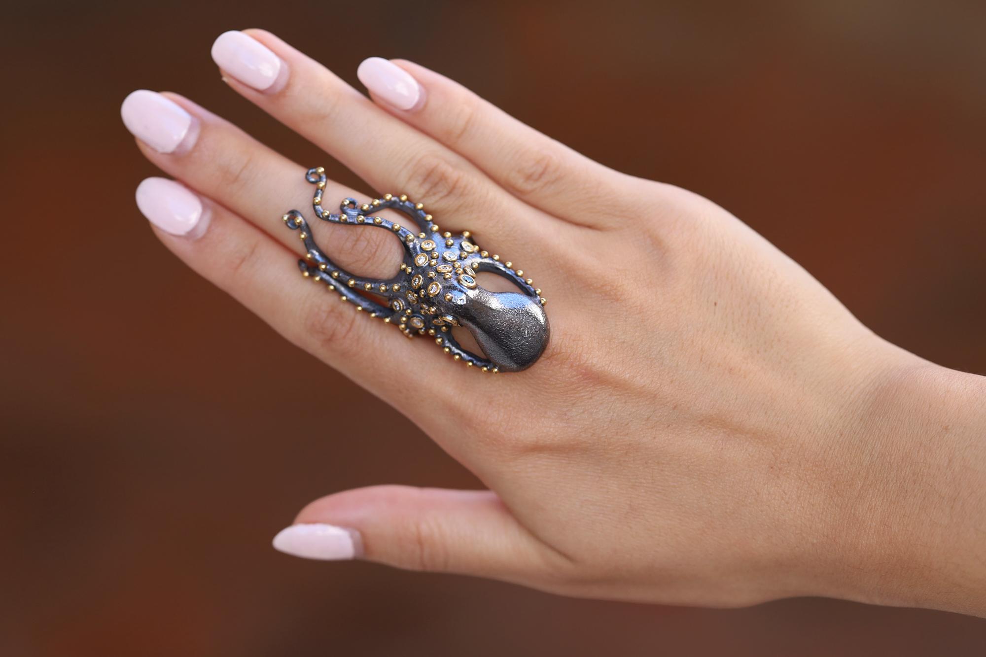 This mysterious 24k gold octopus cocktail ring is adorned with diamond tentacles with an oxidized silver body. The blue diamond eyes will mesmerize you as this intriguing creature wraps around your finger. You'll stop traffic with this cocktail ring