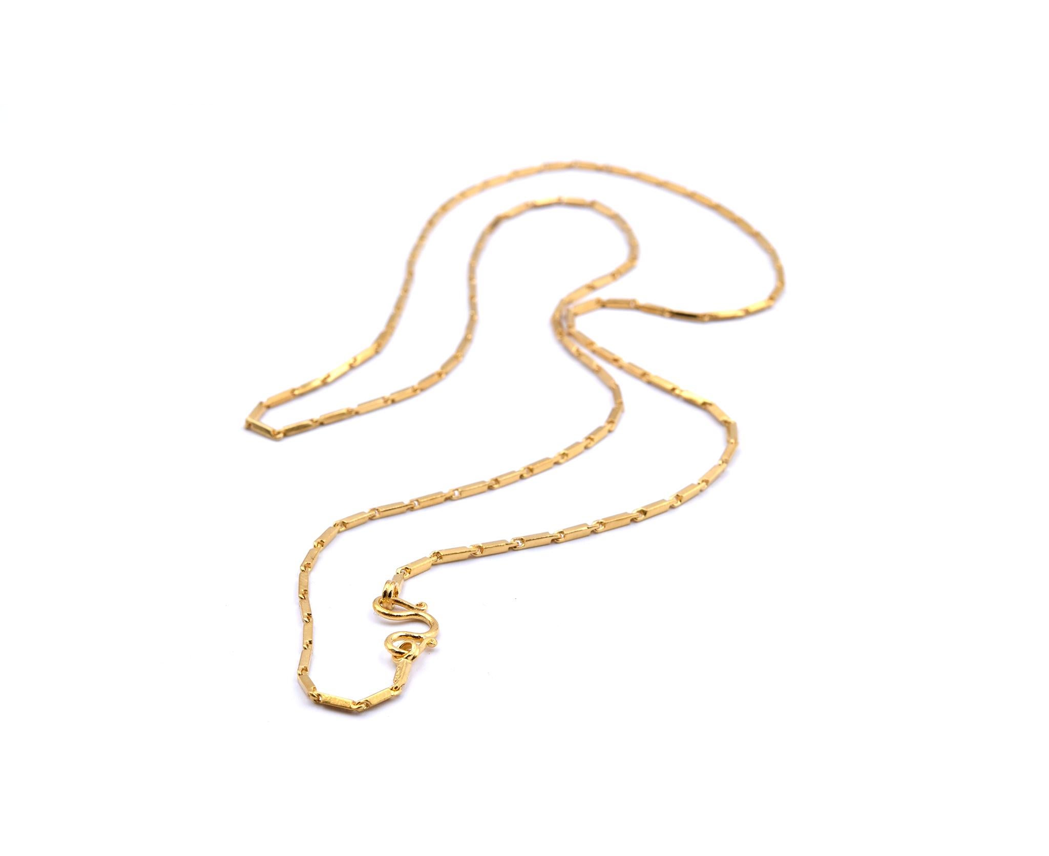 Designer: custom designed
Material: 24k yellow gold
Dimensions: necklace is 25-inches long and measures 1.38mm wide
Weight: 17.21 grams
