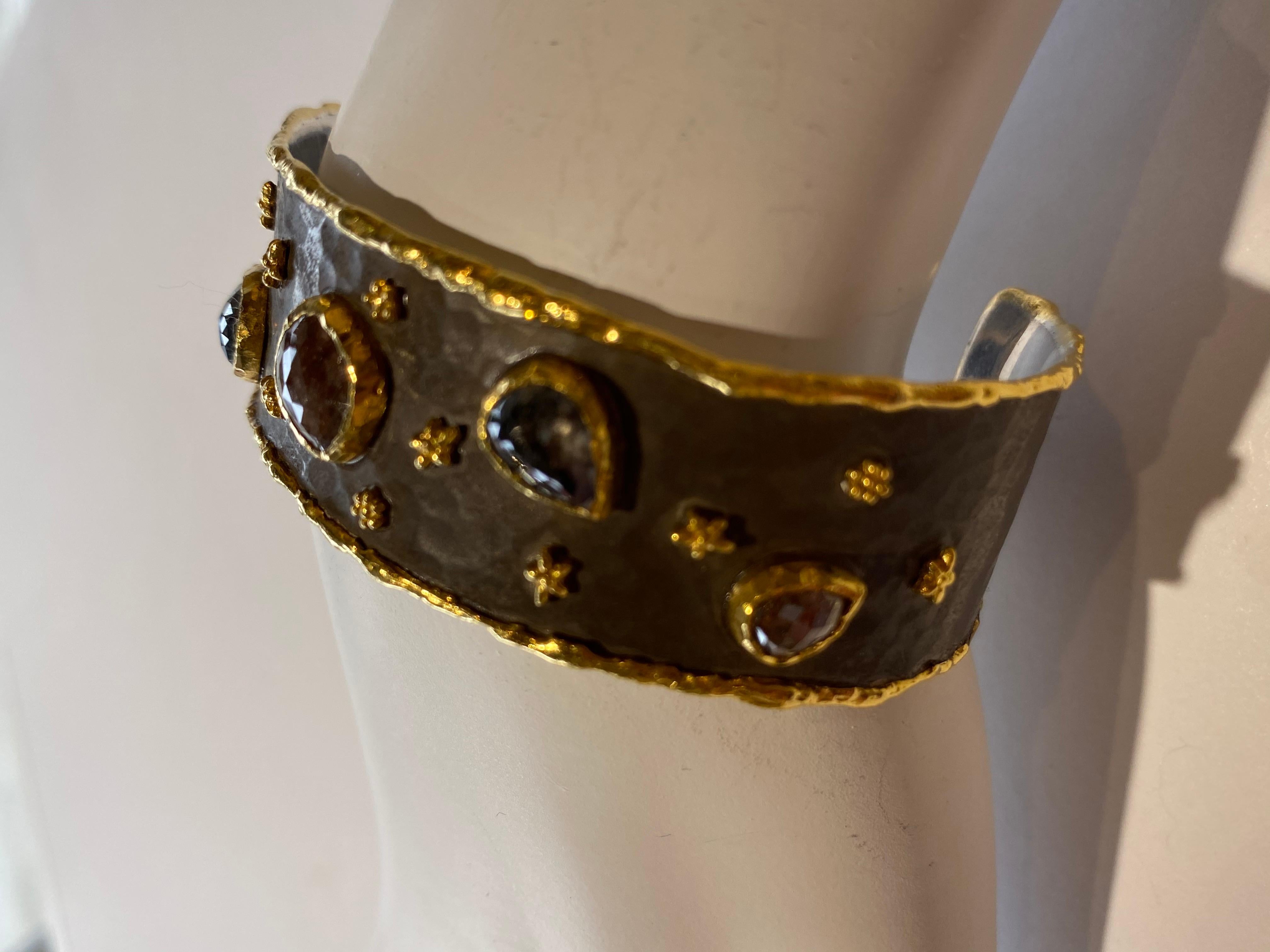 Inspired by the energy pulsating throughout nature, Velyan unites pure metals and gemstones into stunning styles that display the grandeur of fine jewelry. 

This cuff style bracelet features natural colored diamonds and 24k yellow gold stars, on a