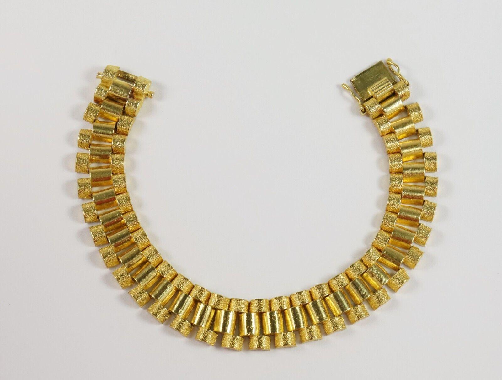 Add a distinctive statement piece to your unique jewelry collection. Appreciate only the best and purest form of gold with this stunning 24k yellow gold bracelet. Featuring alternating smooth inner links accented by textured outer links on both
