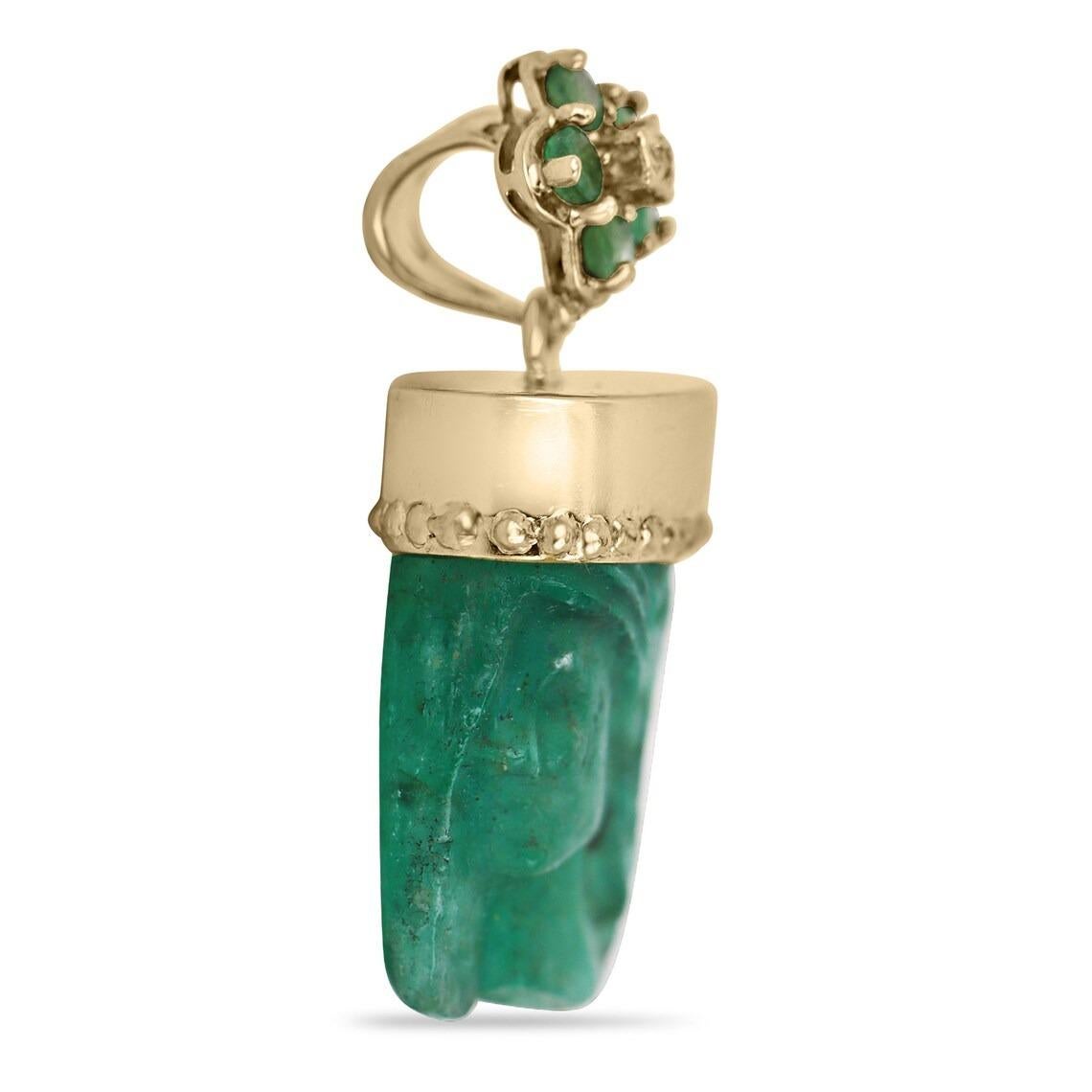 Showcased is a hand-carved, emerald crystal pendant in 14K yellow gold. An estimated 23.75 carat + Colombian emerald crystal is carved with a feminine profile. The piece is perfectly capped by a smooth yellow-gold beaded base and a floral bale. The