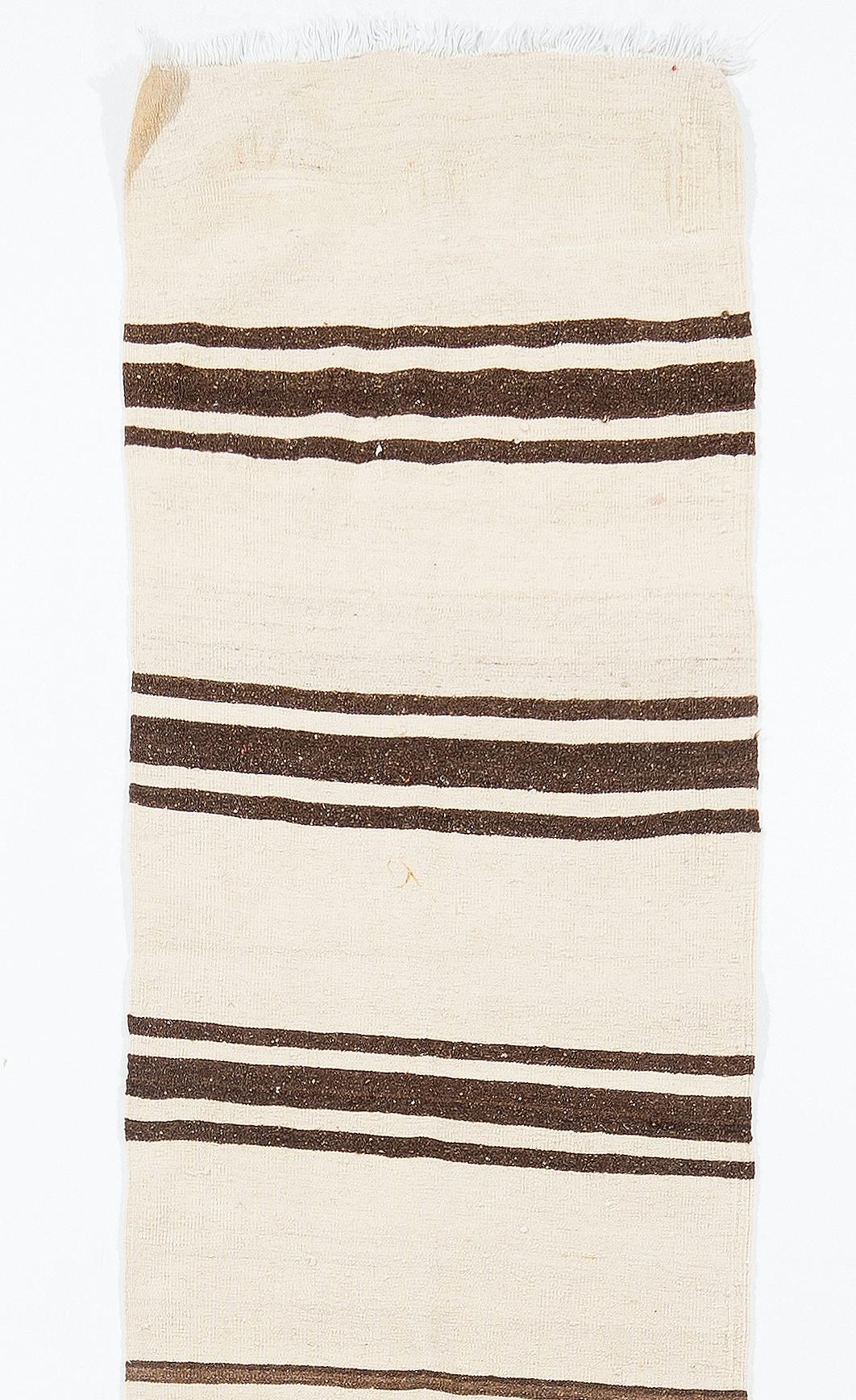 Size: 2.4 x 15.1 ft (70 x 460 cm) - Adjustable.

This beautiful and simple flat-woven runner is made of natural un-dyed wool in shades of brown and beige. It is woven by villagers in Central Anatolia, Turkey around mid-20th century for domestic