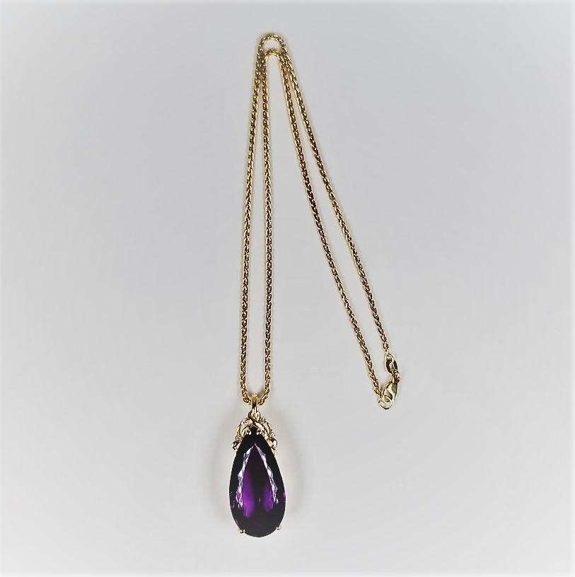 This stunning 25 carat amethyst and diamond enhancer measures 1 1/2 inches in length and is suspended from an 18