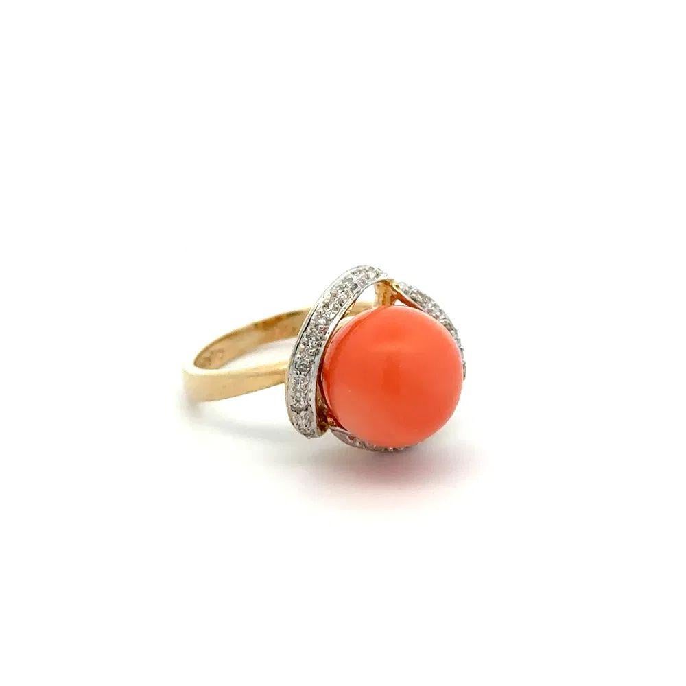 Simply Beautiful! Angel Skin Coral and Diamond Gold Ring. Centering a securely nestled Ball Angel Skin Coral, weighing approx. 2.5 Carat, surrounded by Diamonds, weighing approx. 0.06tcw Hand crafted 14K Yellow Gold mounting. Ring size 6, we offer