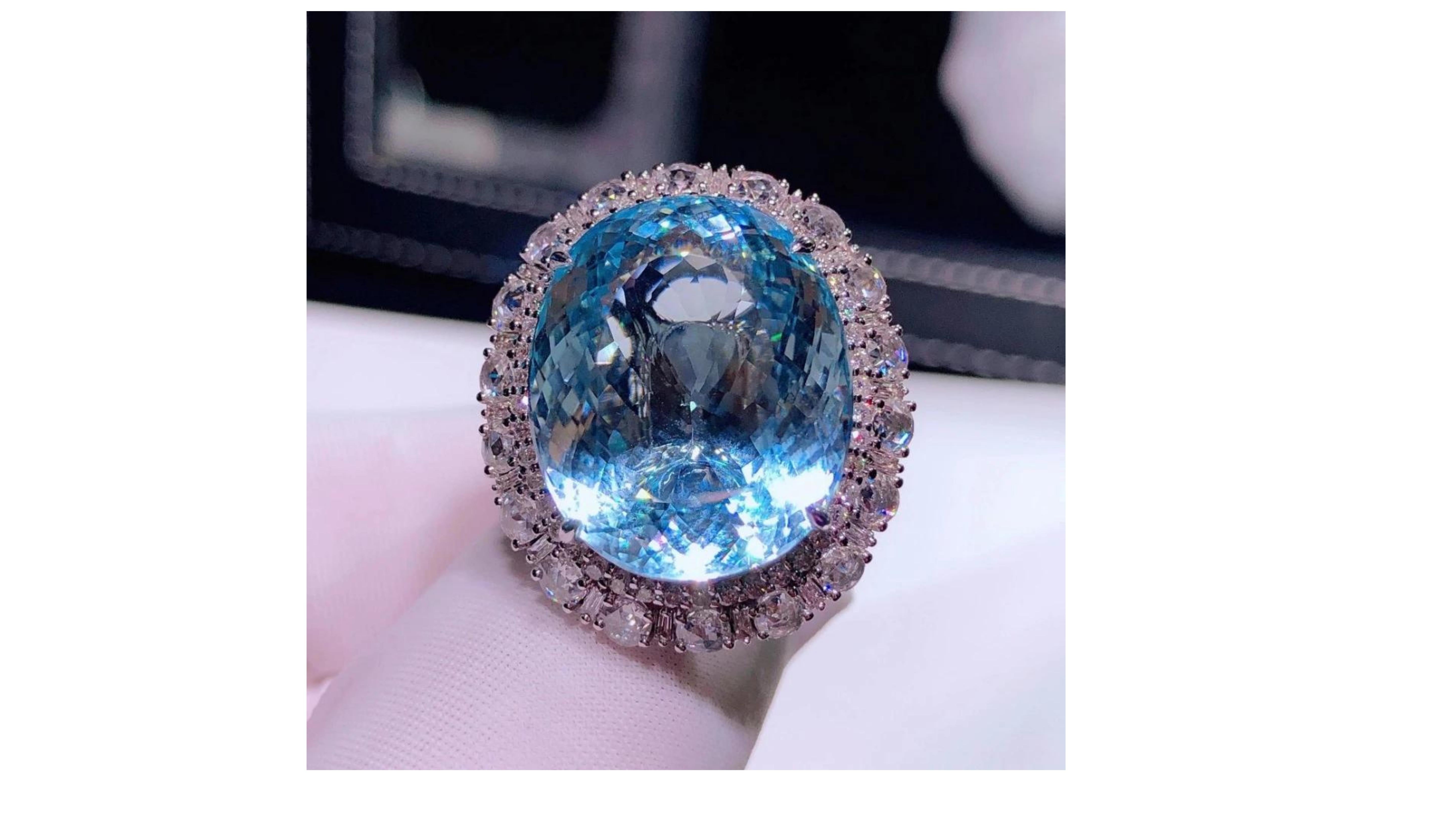 
This 25 Carat  Aquamarine Ring has 106 White Diamonds and is a wow factor as this Large Oval cut shape. Set in 18 Karat White Gold and it has duel use do can be a pendant too. 

Aquamarine with diamonds at each side and sparkling like a crystal