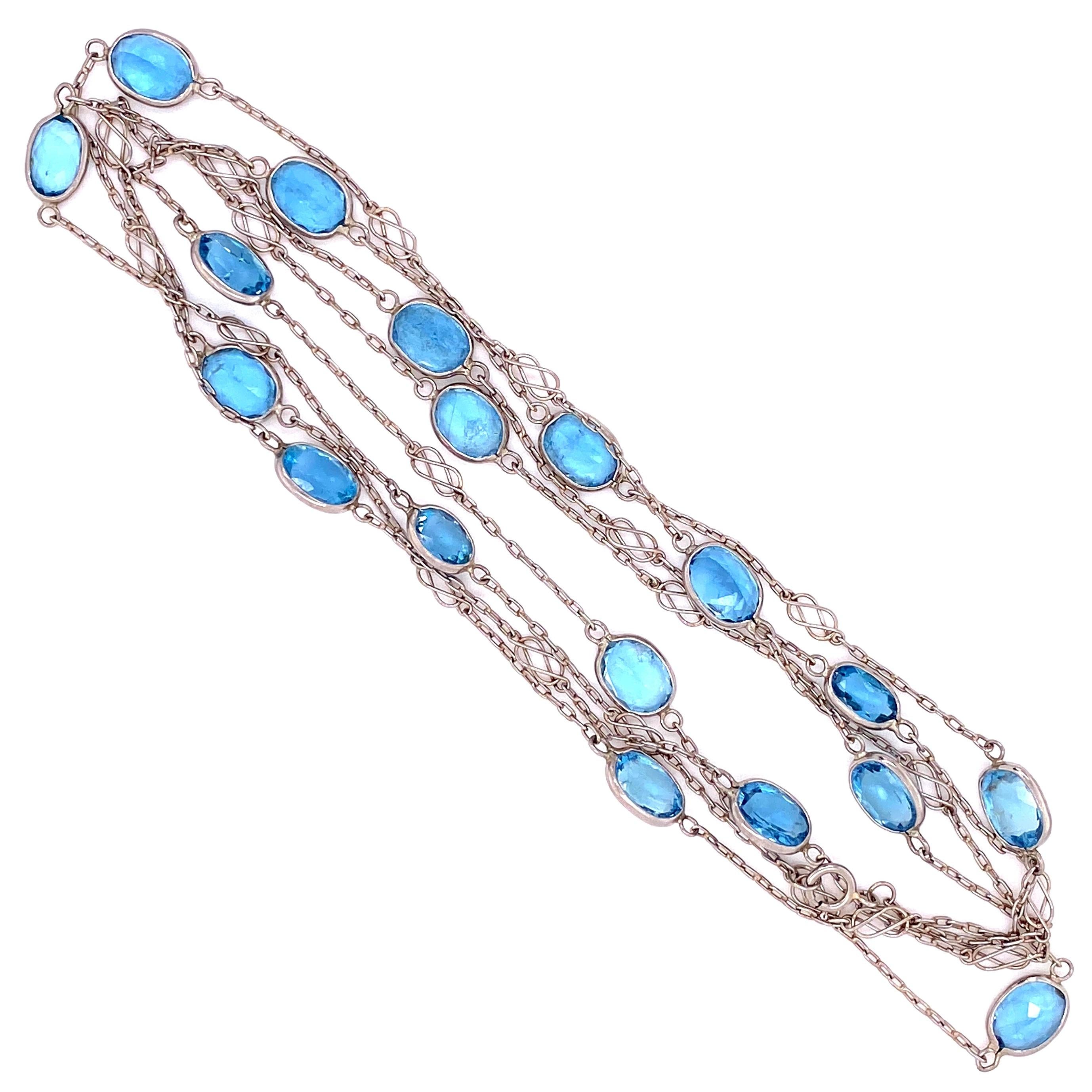 Beautiful, Elegant and finely detailed Necklace featuring oval-shaped Aquamarine Gemstones, inter-spaced with Platinum Link Chain. Approx. Length: 40 inches. The necklace is in excellent condition and was recently professionally cleaned and