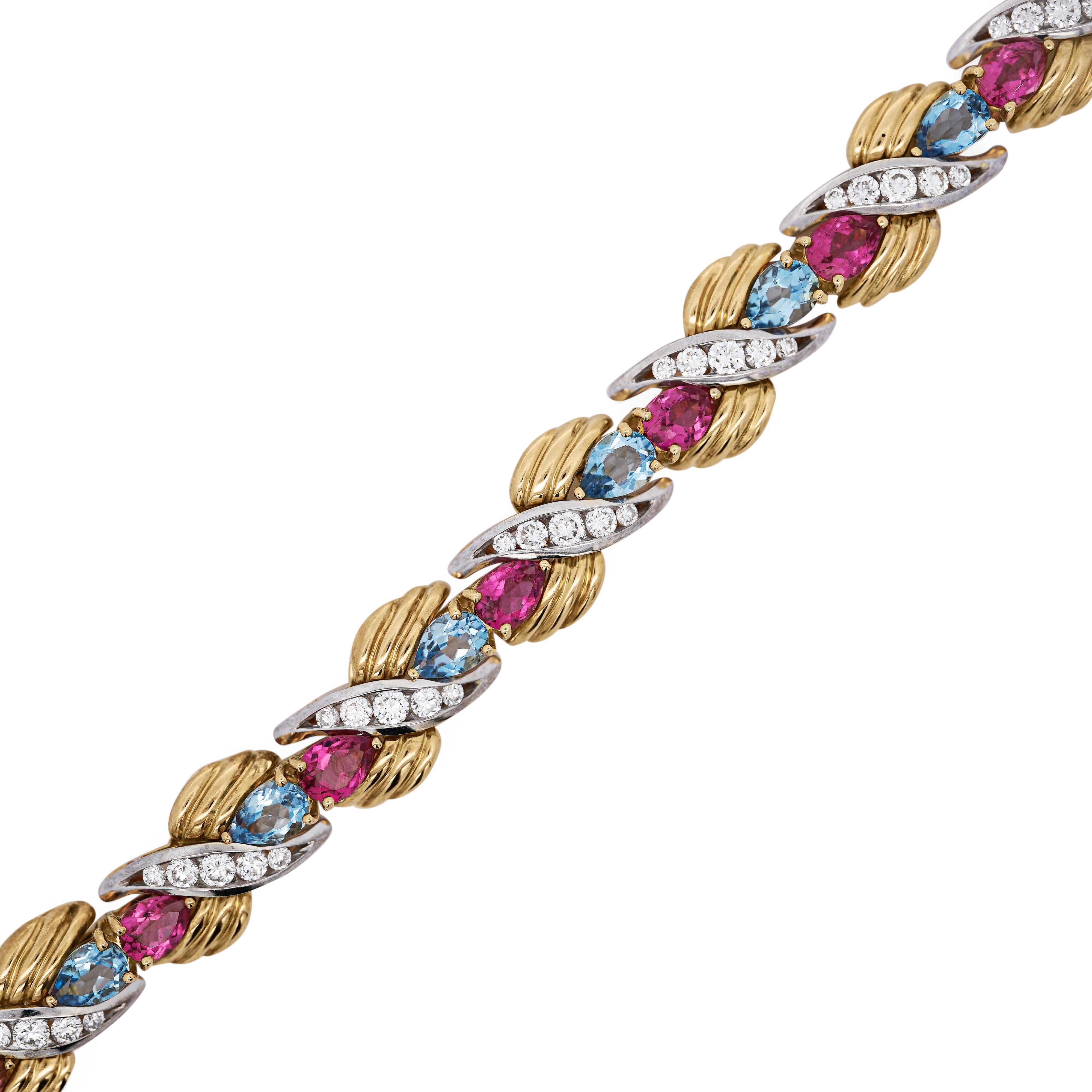 Elegant retro inspired 7-inch bracelet featuring 11.20 Carats of aquamarine and 10.60 Carats of pink tourmaline, accented with 3.60 Carats of round diamonds in platinum. Crafted in solid 18K yellow gold with platinum 950 links and secure box clasp.