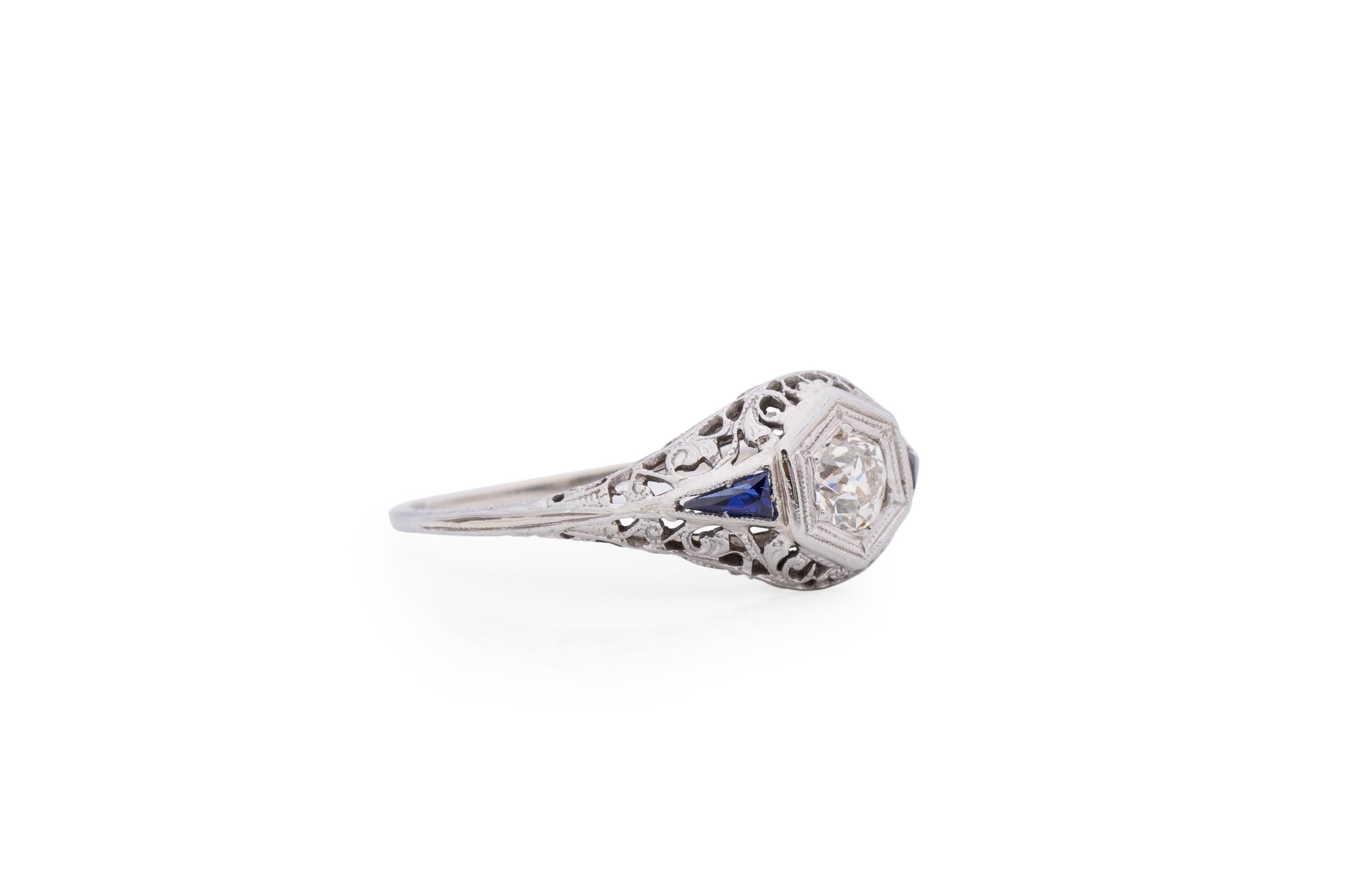 Item Details: 
Ring Size: 8.75
Metal Type: 18 Karat White Gold [Hallmarked, and Tested]
Weight: 2.0 grams

Center Diamond Details:
Weight: .25 carat
Cut: Old European brilliant
Color: J
Clarity: VS

Side Stone Details:
Type: Sapphire,