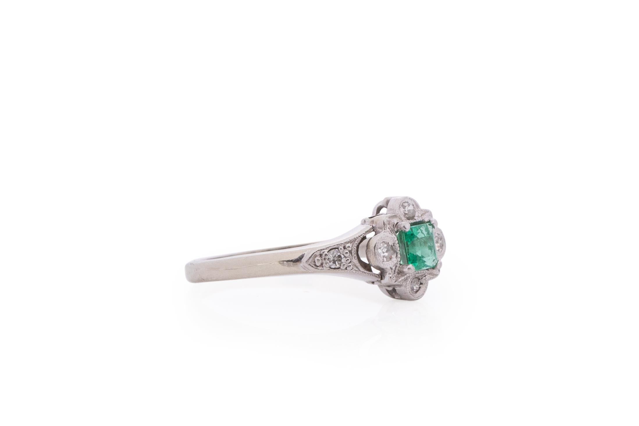 Item Details: 
Ring Size: 6
Metal Type: Platinum [Hallmarked, and Tested]
Weight: 2.1 grams

Center Stone Details:
Type: Emerald, Natural
Weight: .25 carat
Cut: Vintage Step Cut
Color: Green

Side Stone Details:
Weight: .06 carat total weight
Cut: