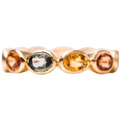 2.5 Carat Blue and Orange Sapphire, 18 Karat Yellow Gold Eternity Band