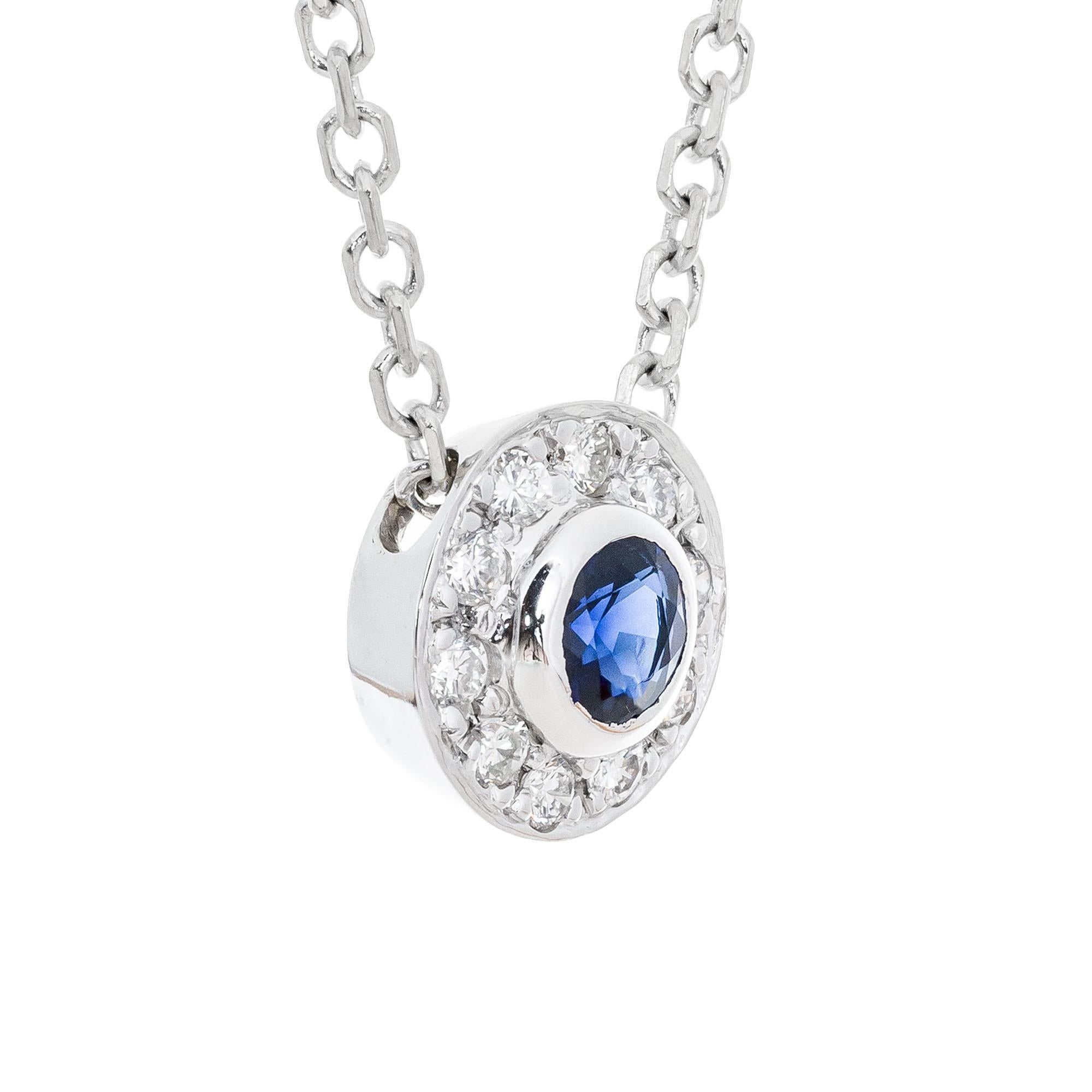 Rich blue round sapphire and diamond pendant necklace. .25ct center blue sapphire with a halo of 10 round brilliant cut diamonds. 16 inch chain. 

1 round blue sapphire, VS approx. .25cts
10 brilliant round cut diamonds, G-H VS approx. .10cts
14k