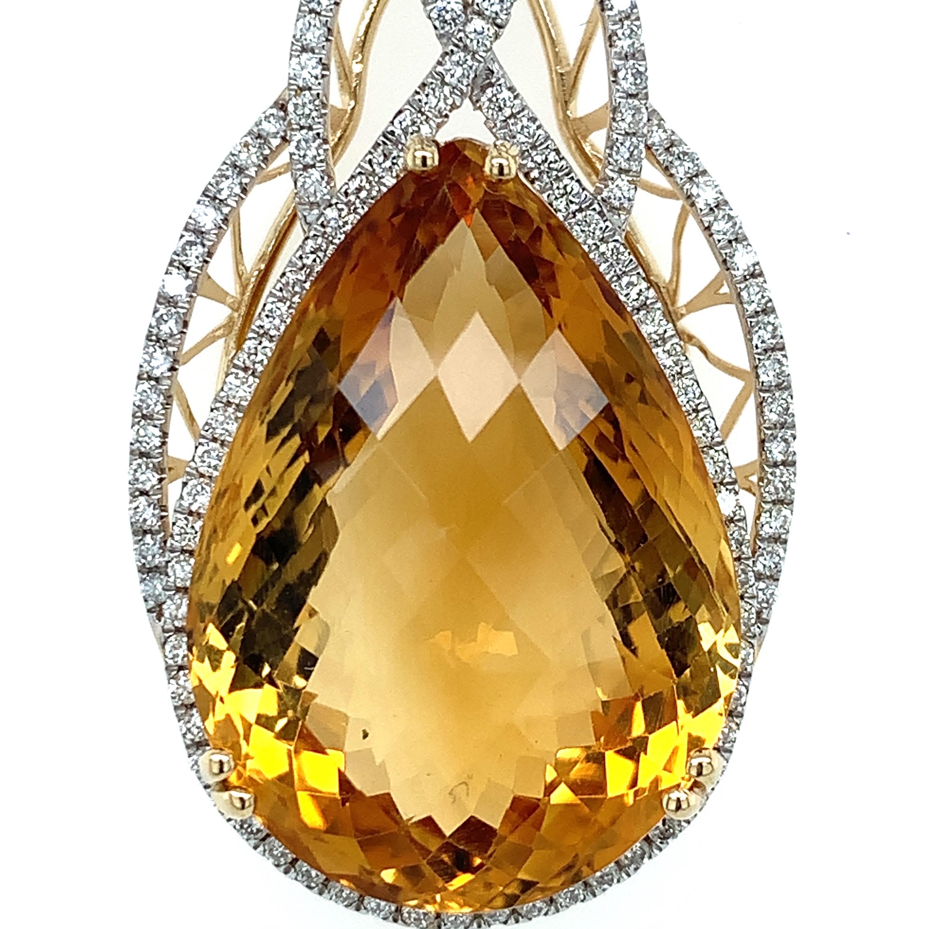 Glamorous design. High brilliance, checkerboard, pear shape faceted, rich golden honey tone natural 25 carat citrine, mounted in high profile open basket with six bead prongs, accented with round brilliant cut diamonds. Handcrafted design set in 14