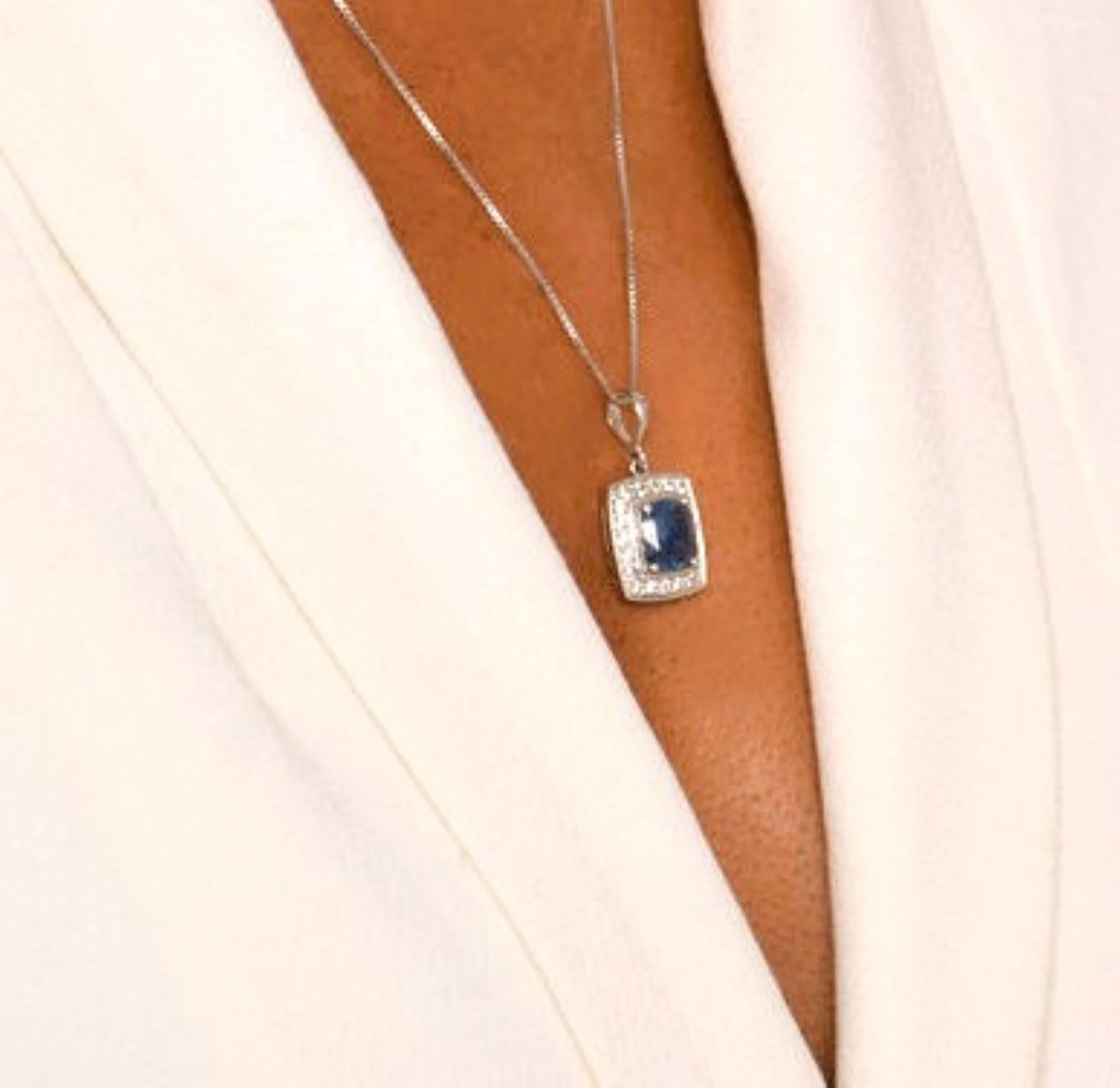 Make a statement with this magnificent 2ct natural blue sapphire pendant of platinum silver. The centerpiece of this pendant is a breathtaking 7.2x6.8mm cushion cut natural blue sapphire, weighing 2 carats, surrounded by 20 sparkling 2.5mm natural