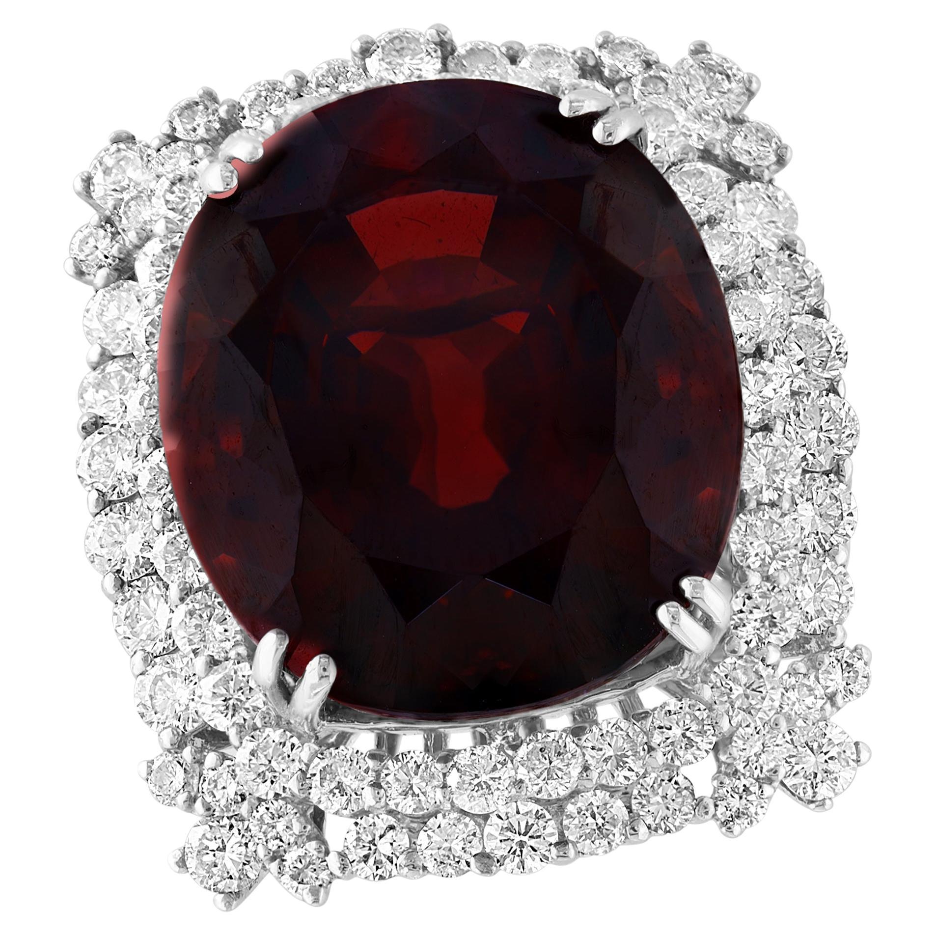 Approximately 25 Carat Cushion Shape Rhodolite Garnet & 5.8 Ct Diamond Ring 18 Kt White Gold, Estate
This spectacular Ring consisting of a single Cushion l Shape  Extremely High quality Rhodolite Garnet approximately 25 Carat.  The  Garnet ring has