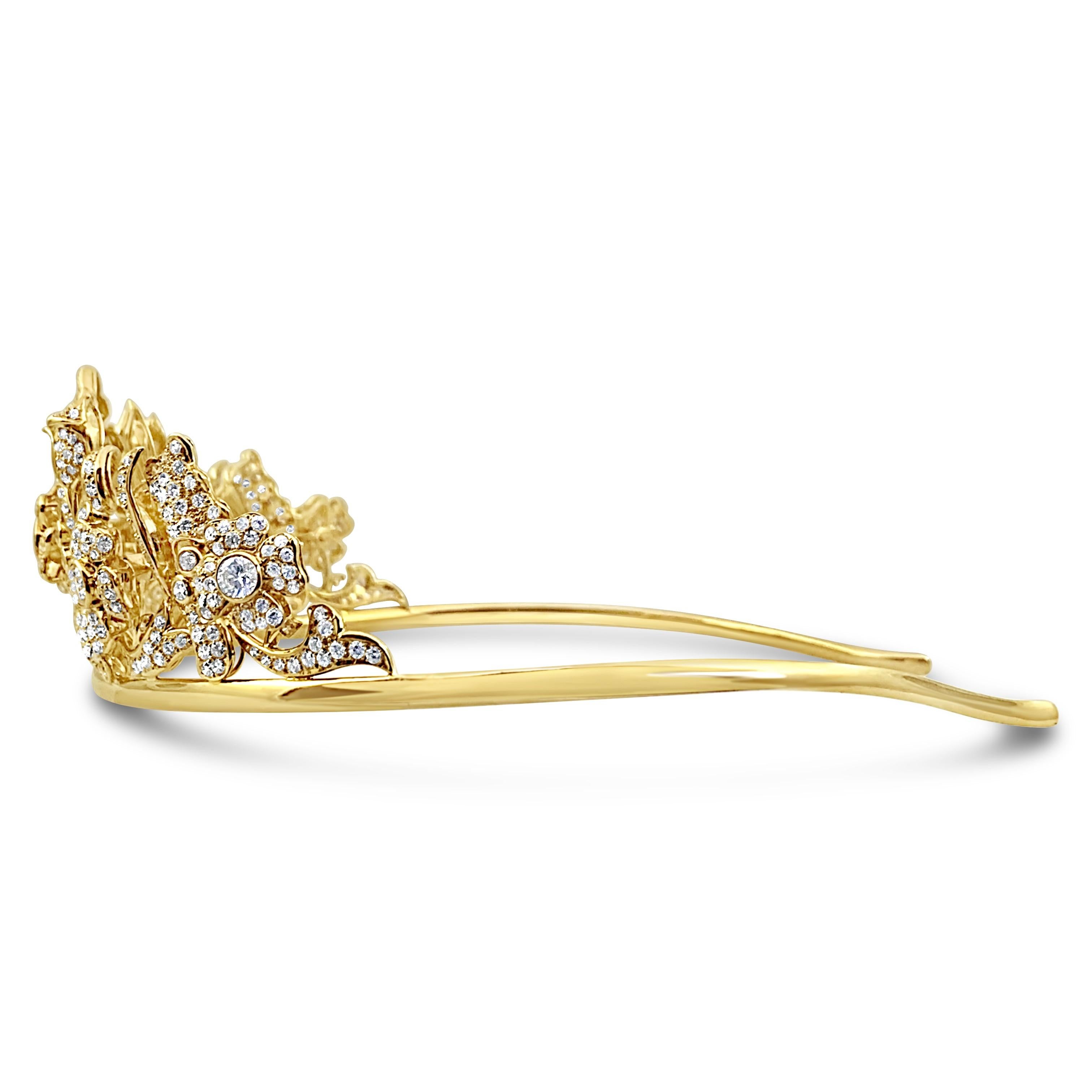 A unique gold diamond tiara with floral motifs, featuring approximately 23 carats set in 18Kt gold. The 6 center diamonds weigh approximately 5 carats, and are F-G color VS1 Clarity. 
Tiara Details 
Total Weight- 96 grams
Dimensions- 50 mm (Height)
