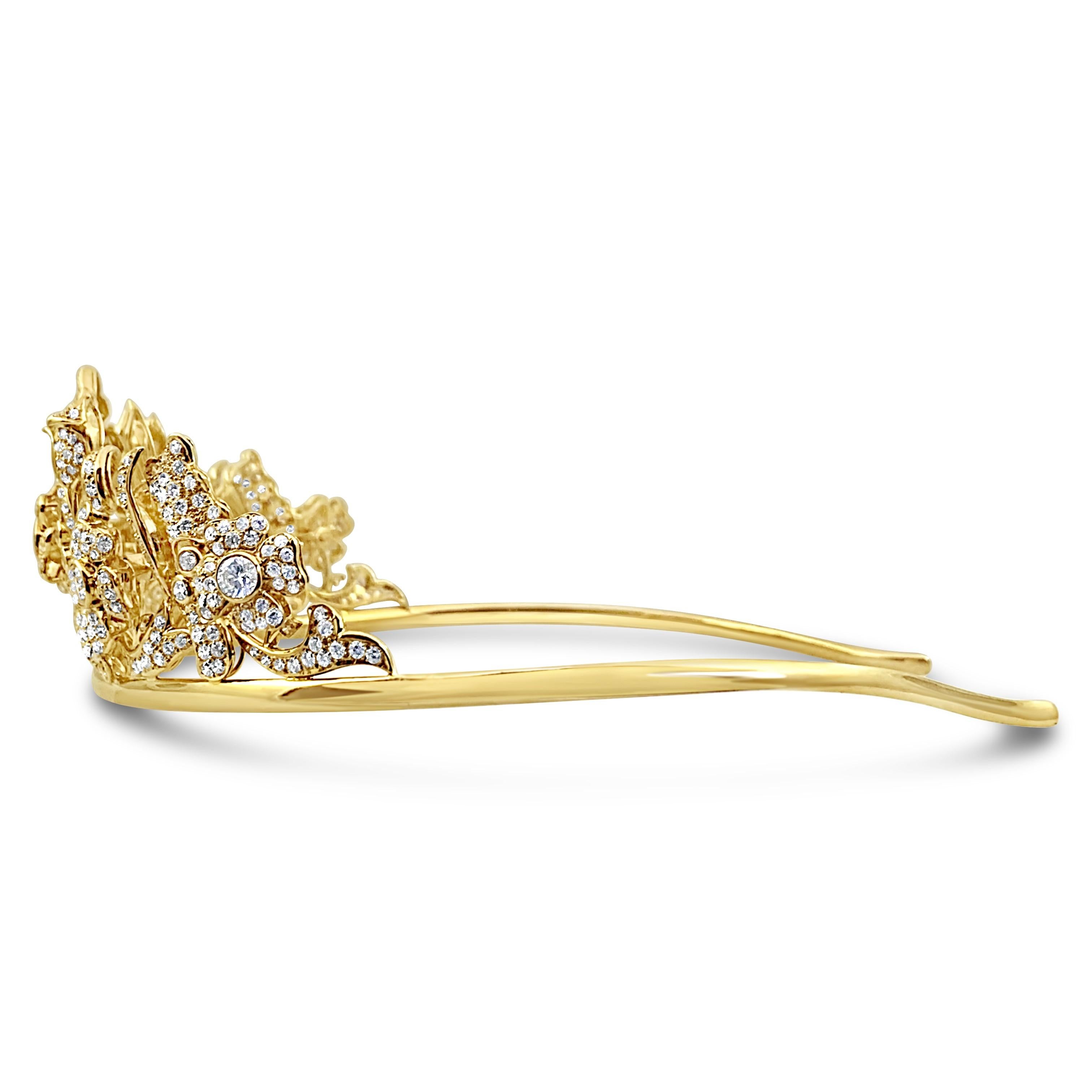 A unique gold diamond tiara with floral motifs, featuring approximately 23 carats set in 18Kt gold. The 6 center diamonds weigh approximately 5 carats, and are F-G color VS1 Clarity. 

Tiara Details 
Total Weight- 96 grams
Dimensions- 50 mm (Height)