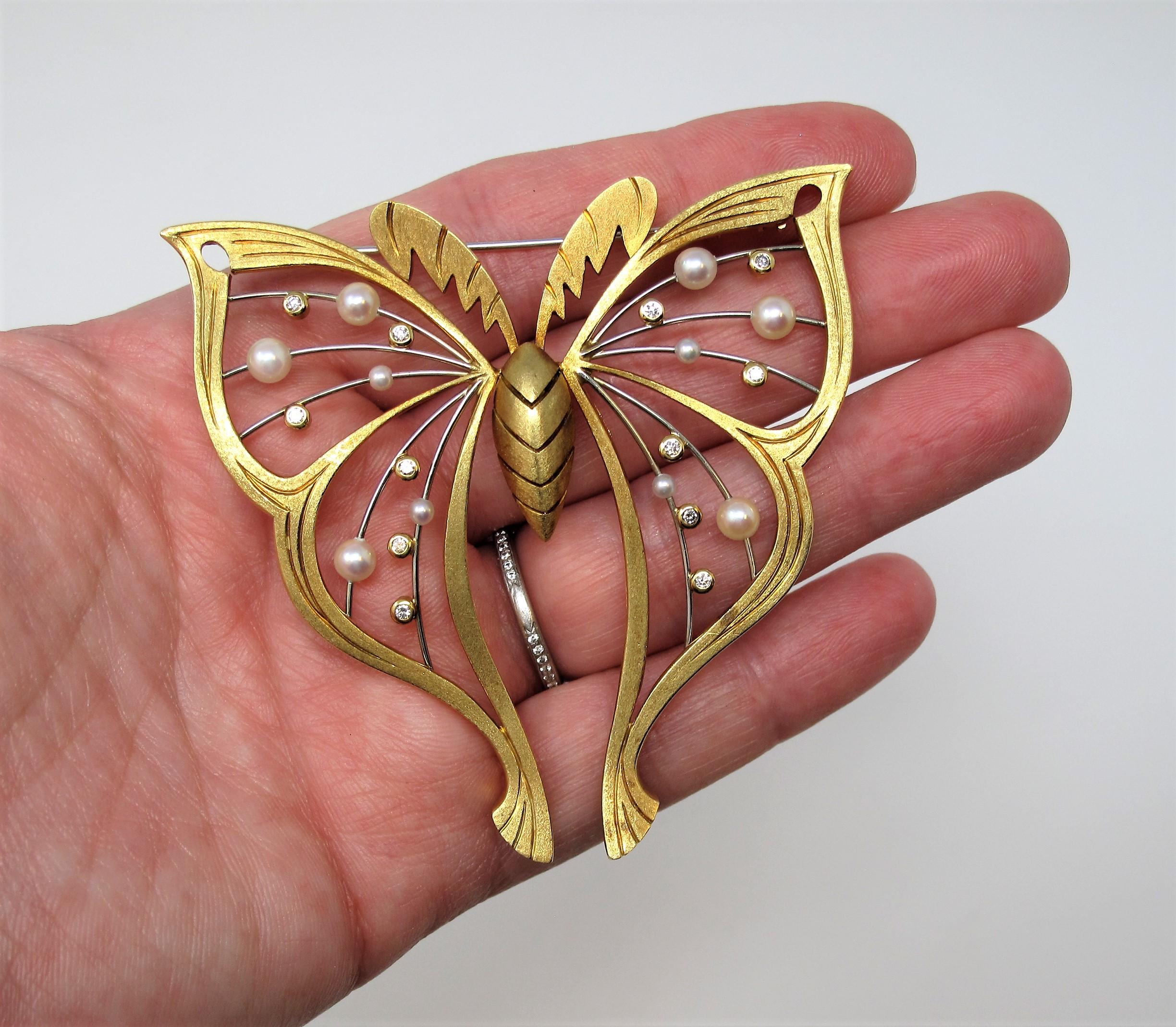 Beautiful and unique handmade 18 karat yellow gold butterfly brooch. This incredible piece is substantial in size and design, while still appearing delicate. Accented by glistening diamonds and pearls, we love how this brooch boasts a modern yet