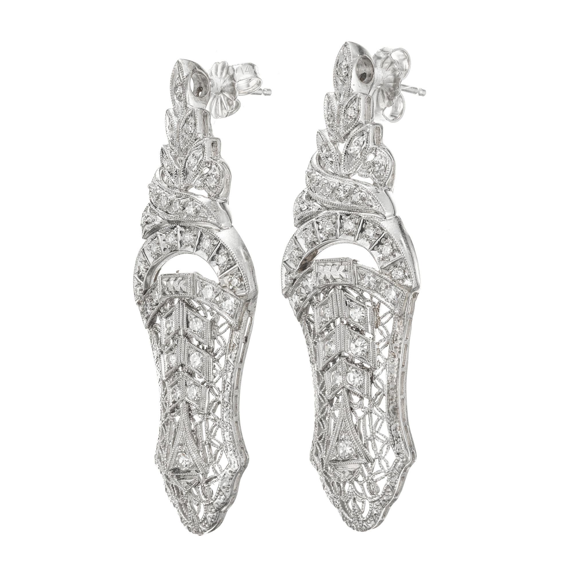 1940's Open work detailed drop diamond earrings. 52 round cut diamonds set in a 14k white gold filigree settings. 

52 round diamonds, approx. total weight .25cts, H, SI
14k White Gold
Tested and stamped: 14k
14k white gold
7.1 grams
Top to bottom: