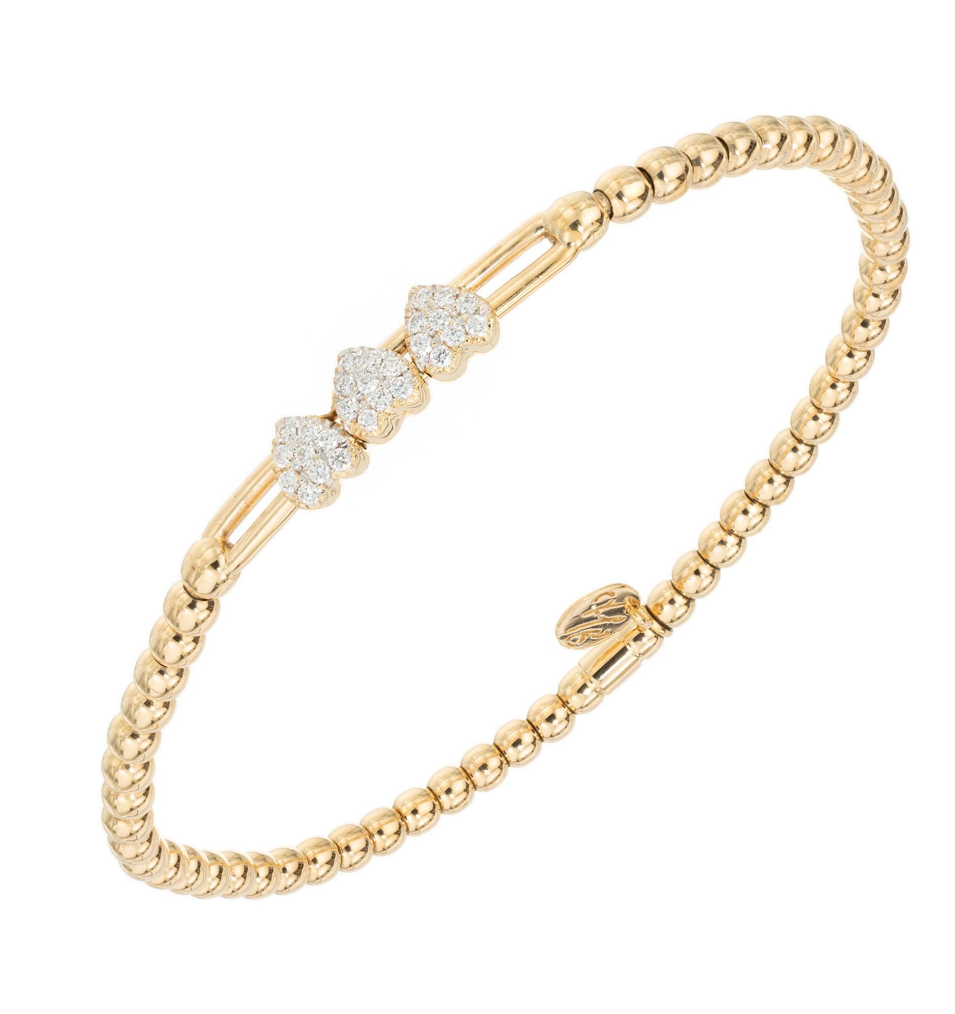 Expandable diamond bracelet. 3 bezel set diamond cluster hearts. 18k gold yellow gold stretch bead bracelet with three bezel set diamond pave hearts, each containing 9 round brilliant cut diamonds, mounted on a center section that slides. Expands to