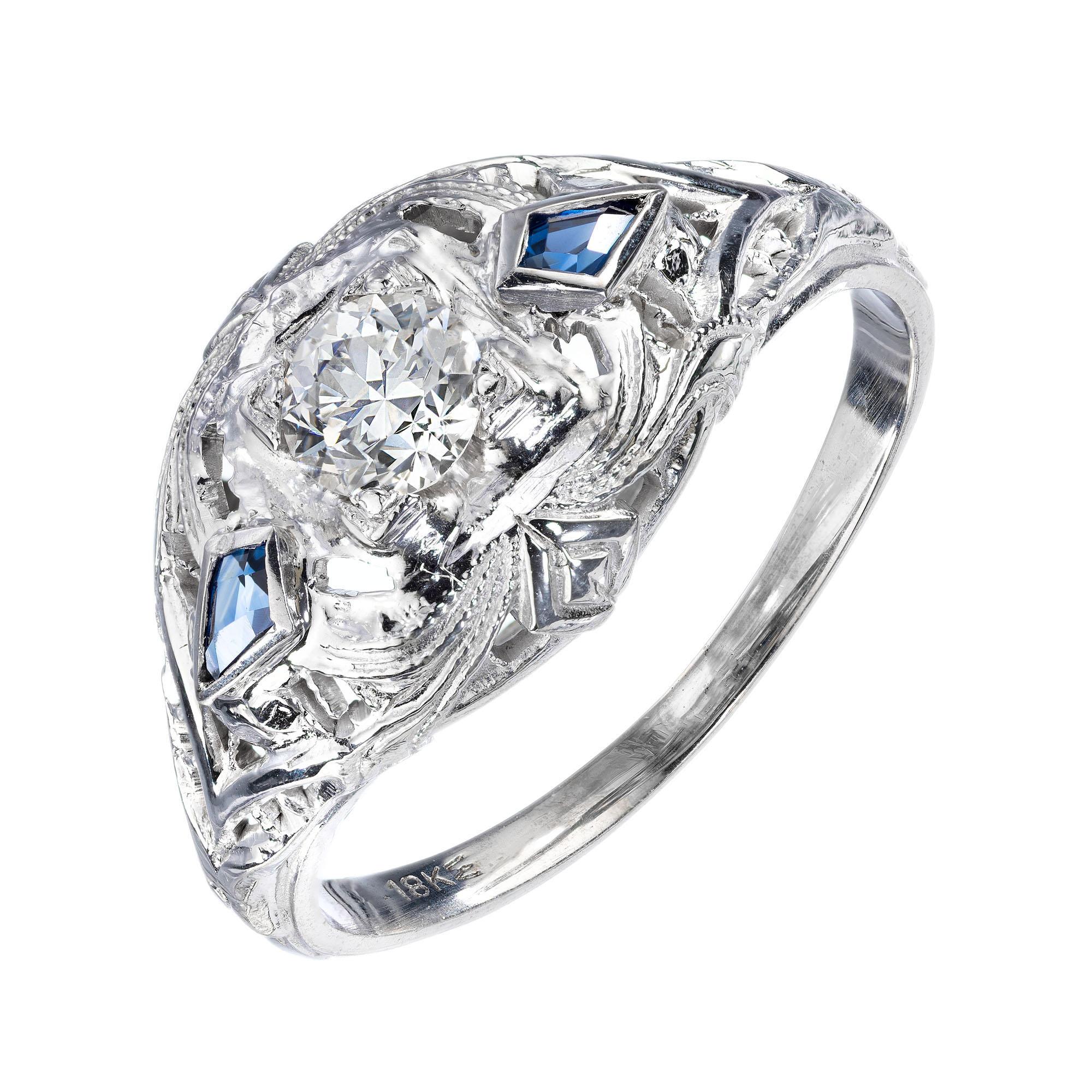Vintage 1930's diamond and sapphire filigree engagement ring. Dome style with a old euro center stone and two kite shaped calibre cut sapphires in a 18k white gold setting. 

1 old European cut diamond, I SI approx. .25ct
2 calibre cut kite shape
