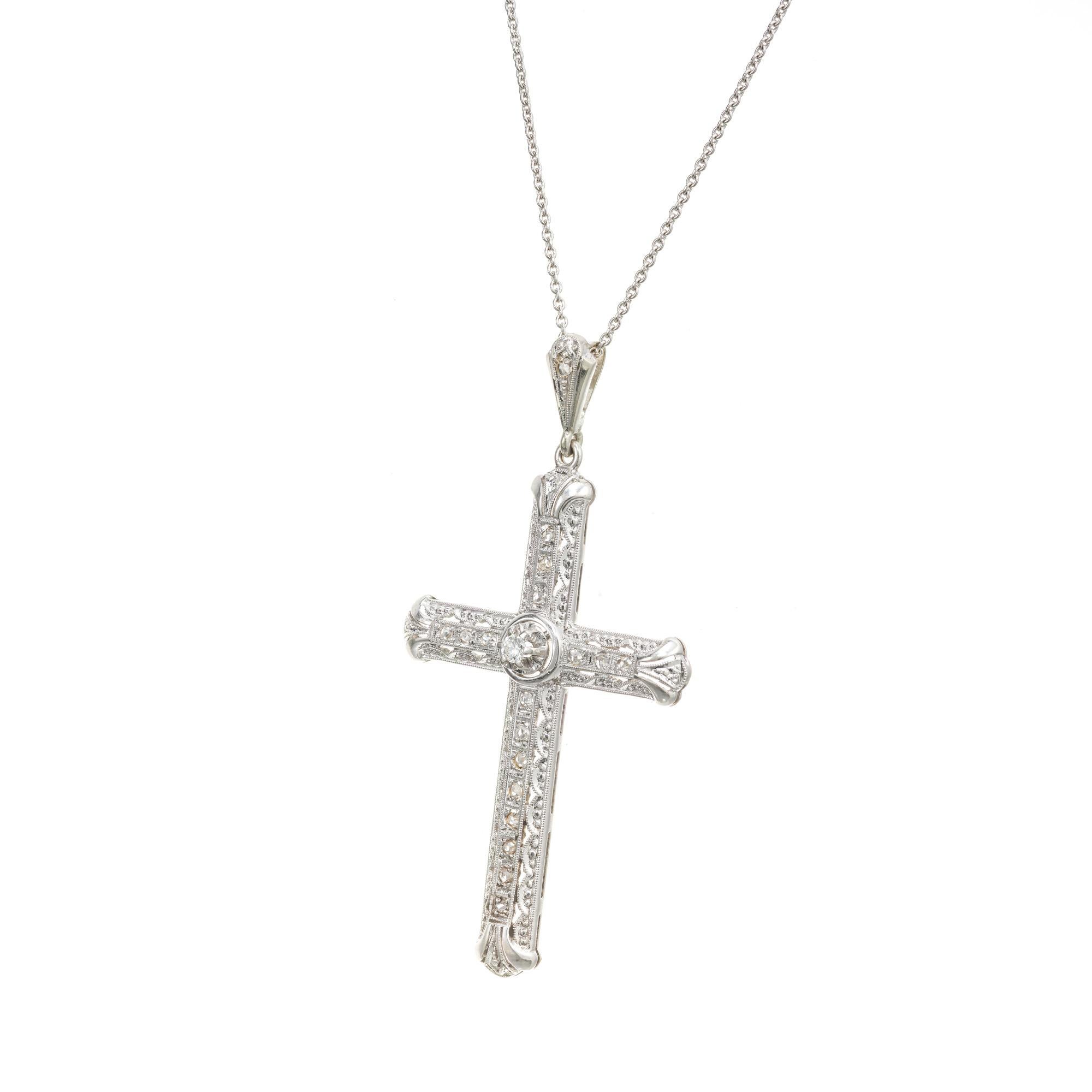 Vintage 1925-1930 18k white gold cross with excellent detailing, 17 rose cut diamonds and one brilliant cut center diamond. 18k white gold 18 inch chain. 

1 round diamond, I SI approx. .4cts
17 rose cut diamonds, H-I VS- SI approx. .21cts
18k white