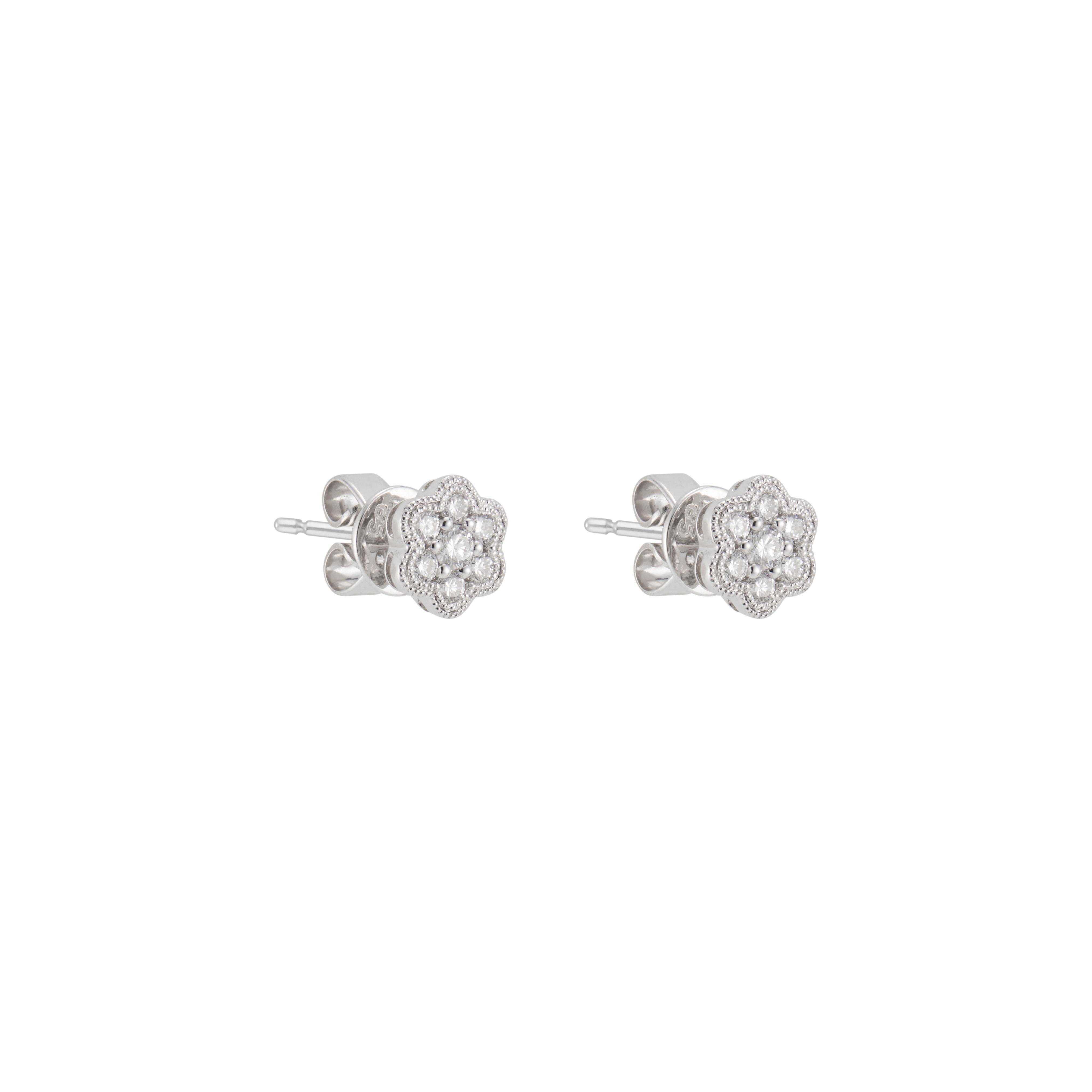 Diamond cluster stud earrings.  14 round brilliant cut diamonds in 14k white gold flower settings.  

14 round brilliant cut diamonds, G VS approx. .25cts
14k white gold 
Stamped: 14k
6.3 grams
Top to bottom: 5.89mm or .25 Inch
Width: 5.89mm or .25