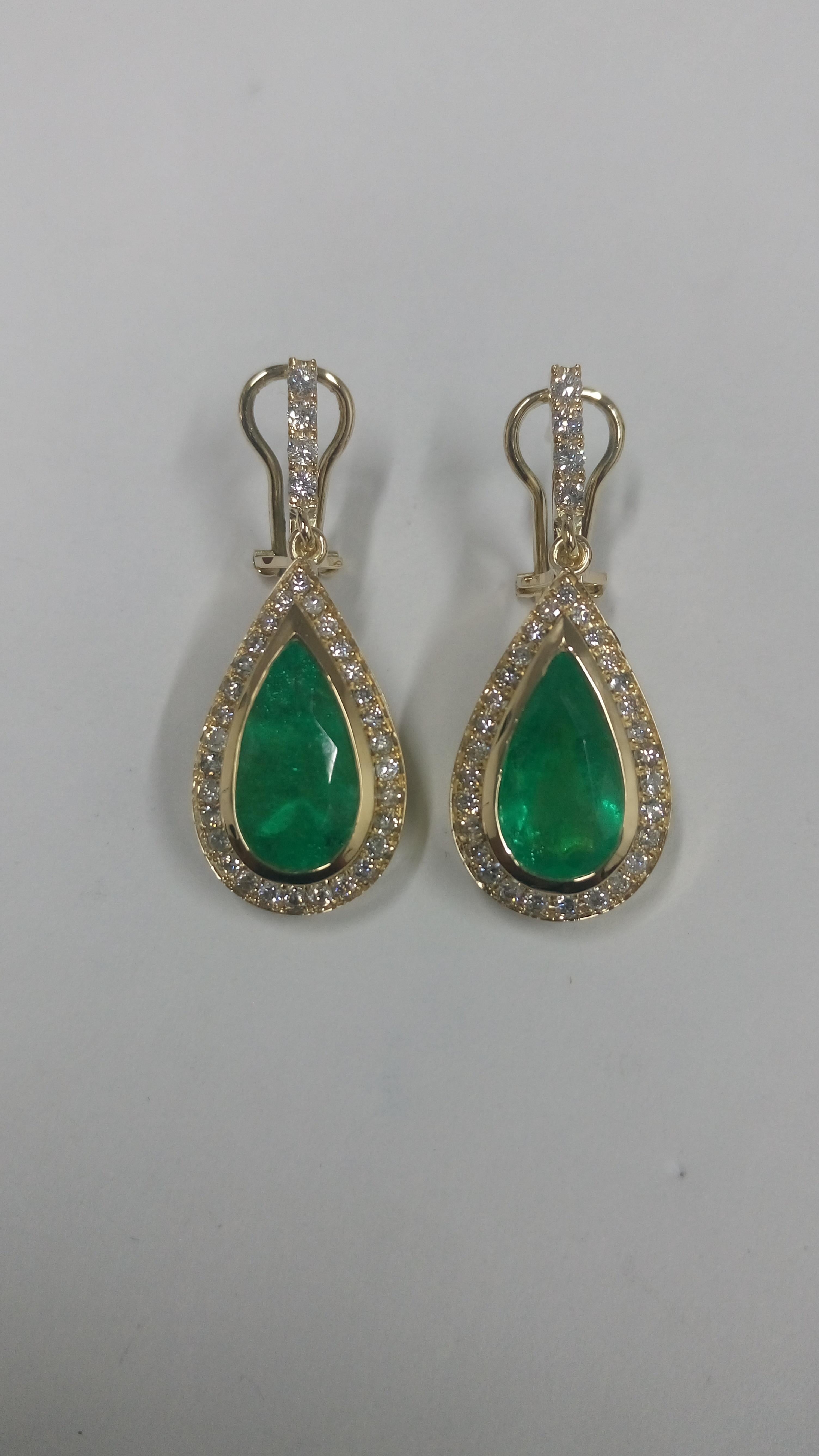 Each earring contains a 2.50 carat natural Colombian emerald, set in 18K yellow gold and adorned with over a carat of diamonds.