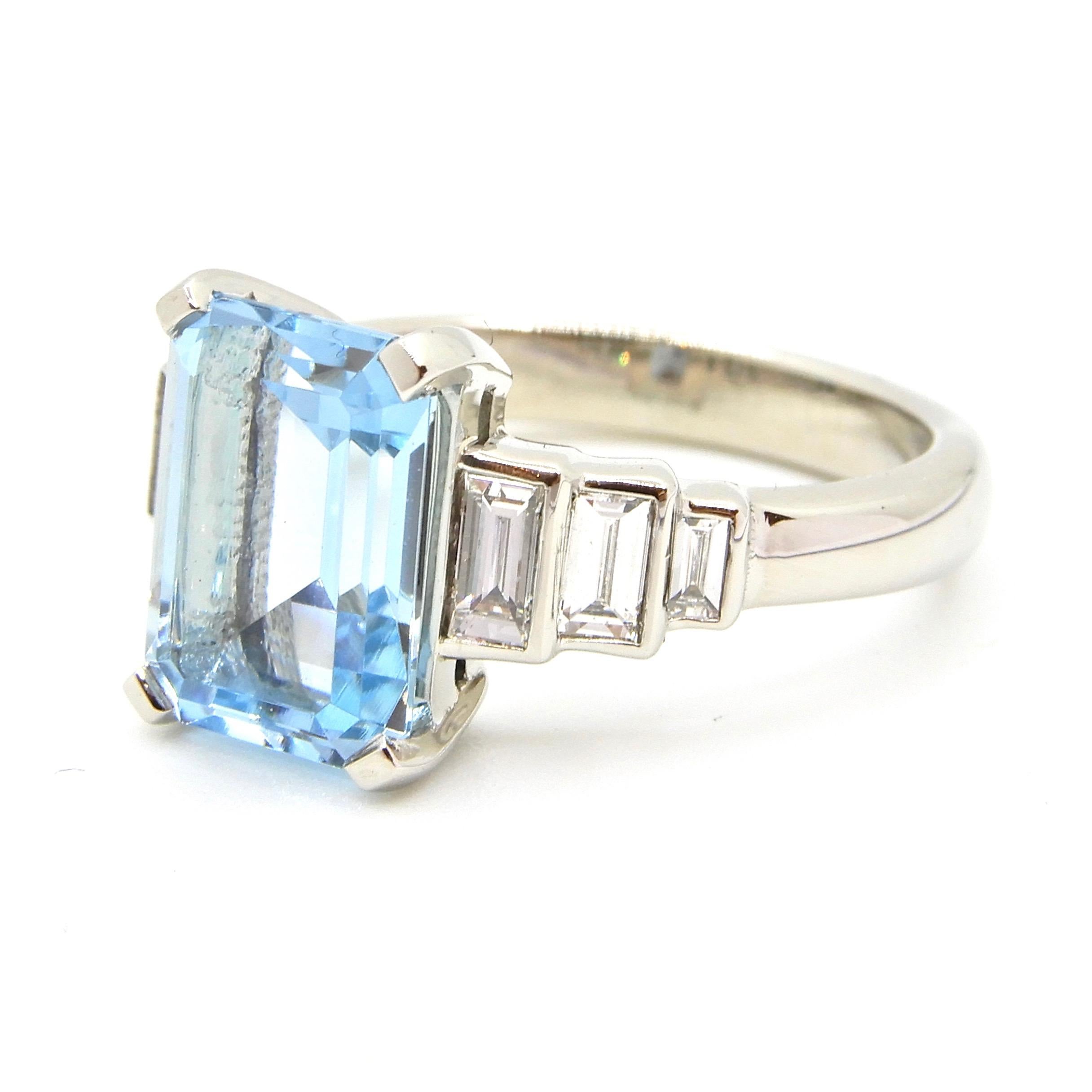 This beautiful 2.5 Carat Emerald Cut Aquamarine Diamond Platinum Ring is a truly classic piece. Designed with empire lines and steps in mind, the bezel set baguette diamonds really show off the centrepiece emerald cut Aquamarine to its full
