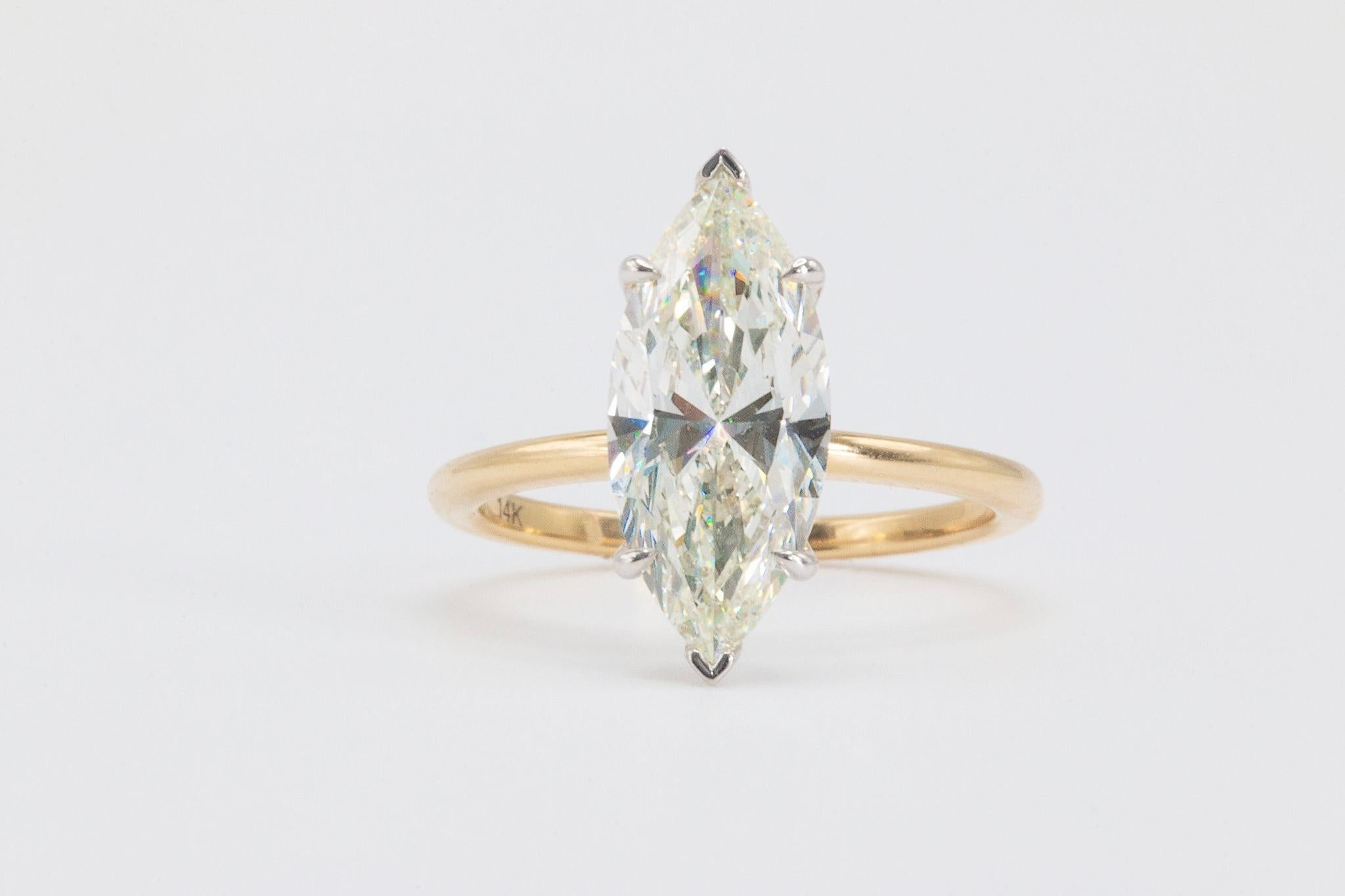 2.5 Carat GIA Marquise Cut Diamond in 14k Yellow Gold Solitaire Ring

Make a Striking Impression with This Elegant Marquise Diamond Ring. This exquisite ring showcases a stunning marquise-cut natural diamond weighing approximately 2.5 carats. GIA