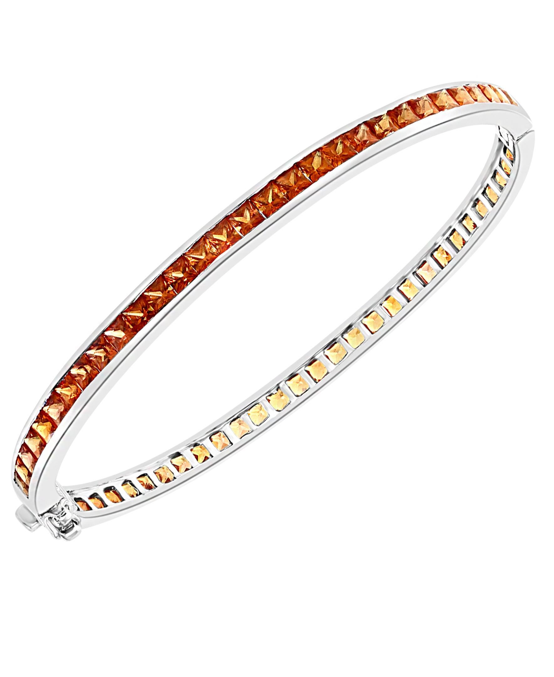 25 Carat  Natural Orange Sapphire Bangle /Bracelet Pair In  14 Karat White Gold 25 Grams
It features a bangle style  Bracelet crafted from  14 karat White gold and embedded with   total approximately 13 Carats natural orange sapphires in  Princess