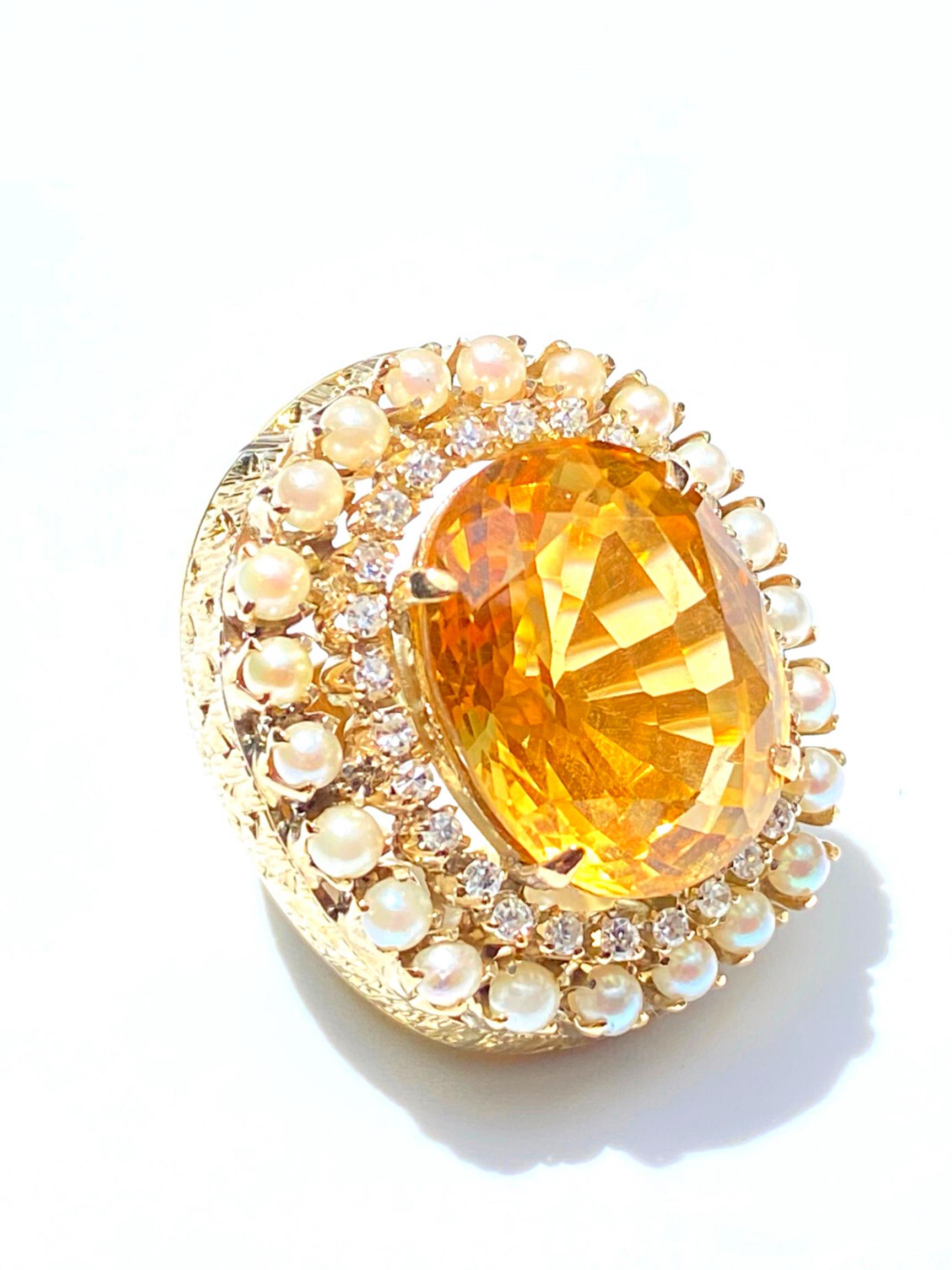 Centering a lovely Vivid Orange ~25 Carat Oval-Cut Citrine, framed by 27 Round-Brilliant Cut Diamonds and 22 